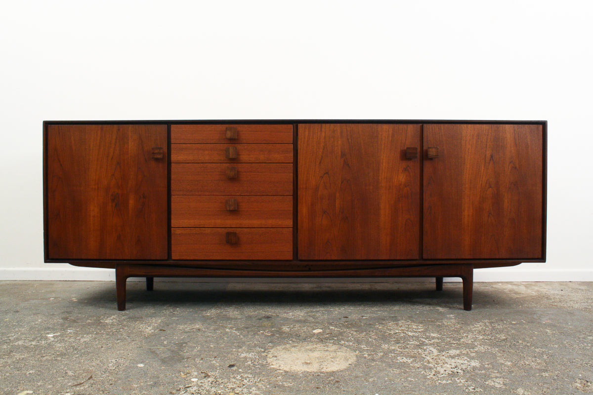 Front view of a mid century sideboard designed by Kofod Larsen for British manufacturer Gplan. Made of Teak. With distinctive square Rosewood handles.