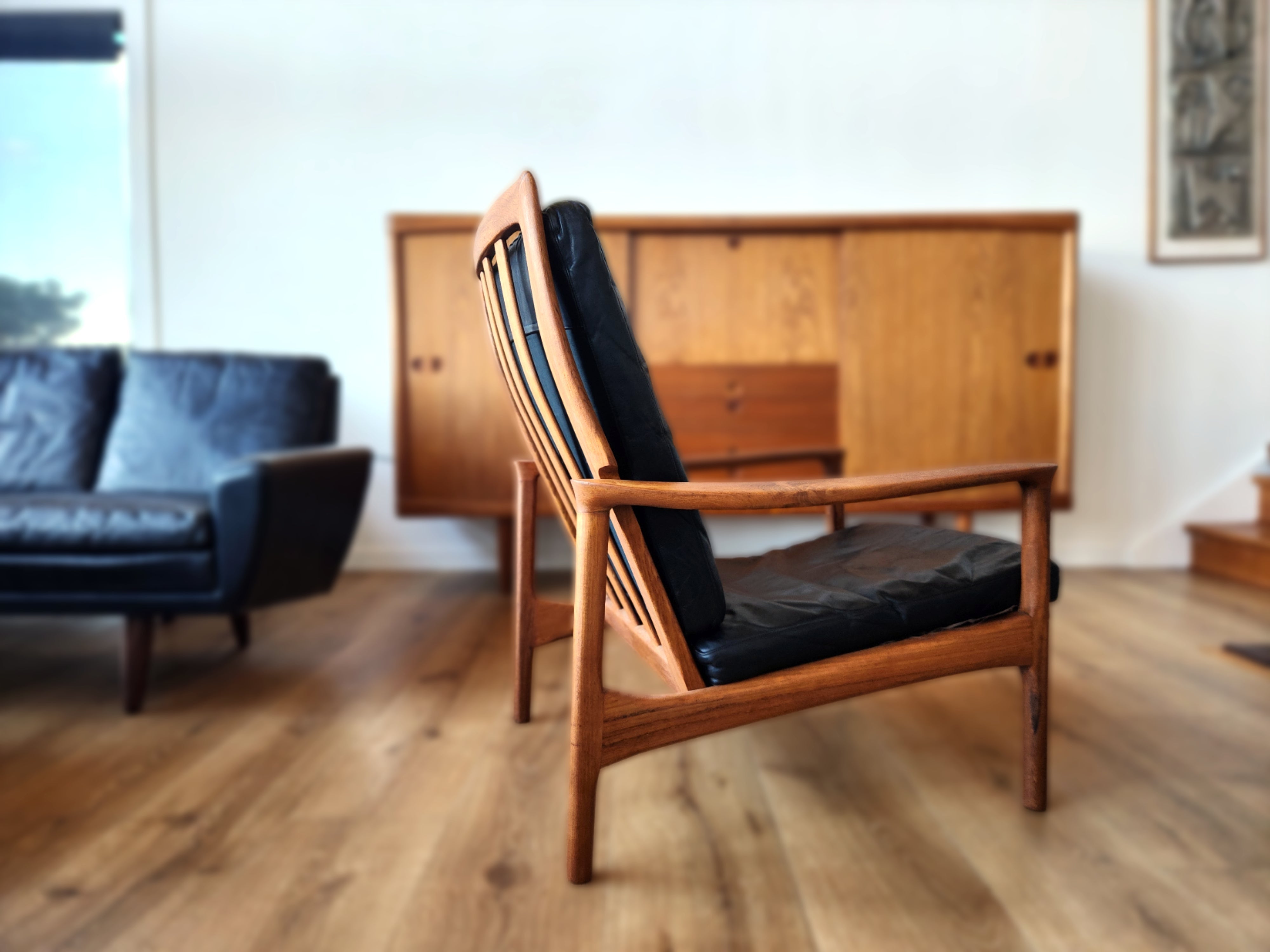 A pair of Danish mid century chairs by Folke Ohlsson. In solid Teak with blue upholstery.
