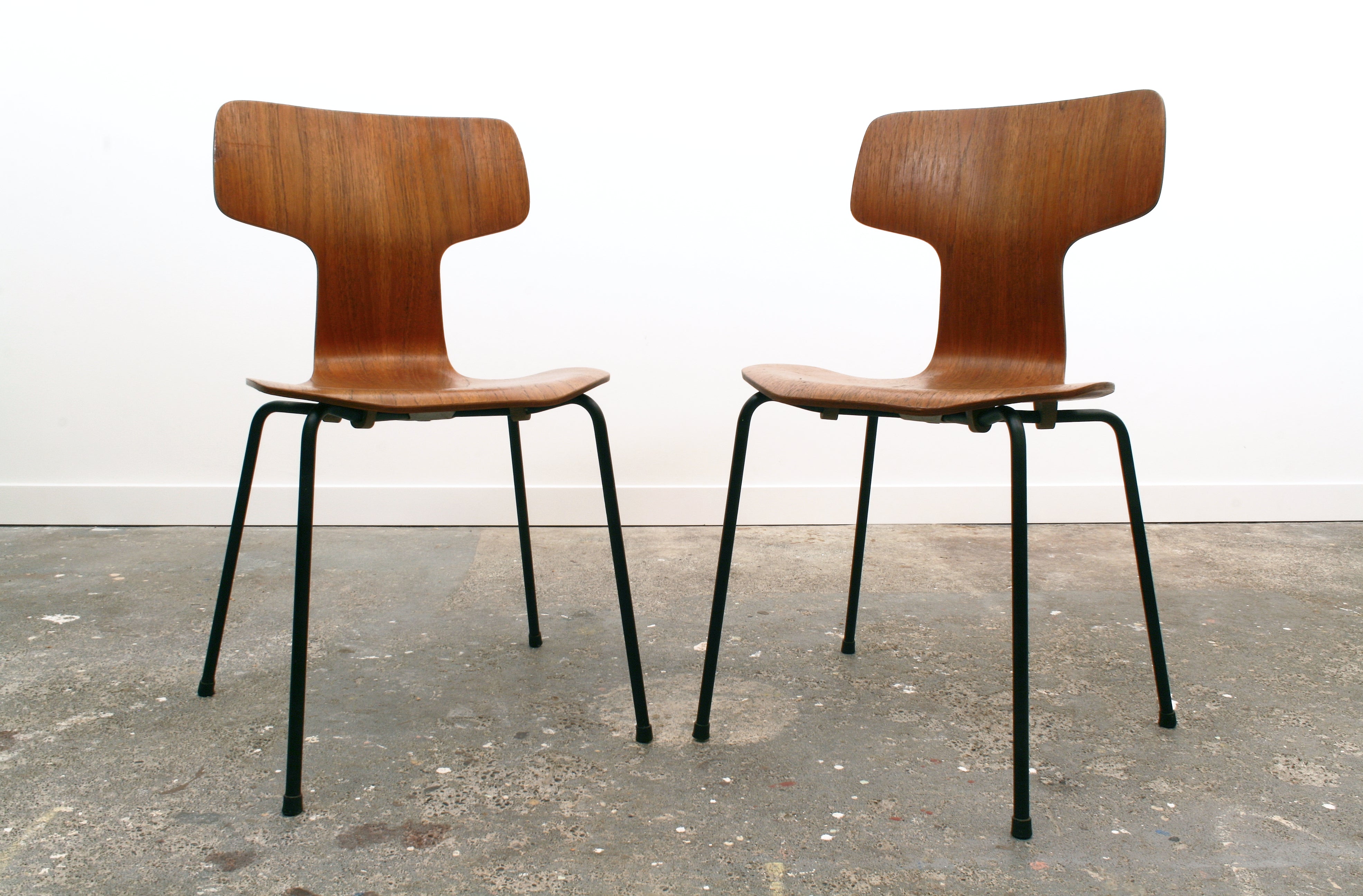 A pair of Teak, model 3103, mid century dining chairs by Arne Jacobsen. Known as the 'Hammerhead' and dated 1966.