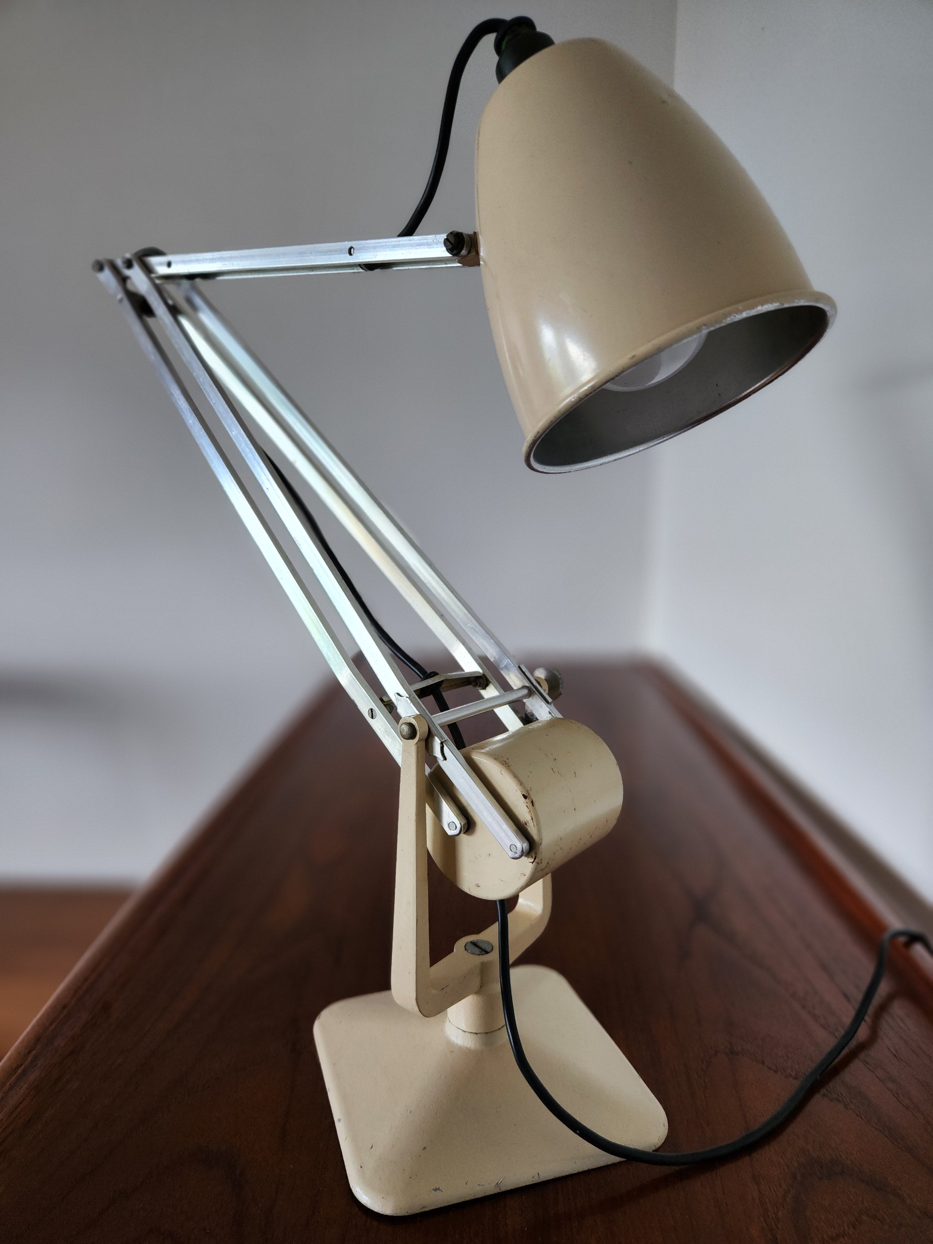 Mid Century Anglepoise lamp. viewed from the front slightly angled right with shade pointing down.