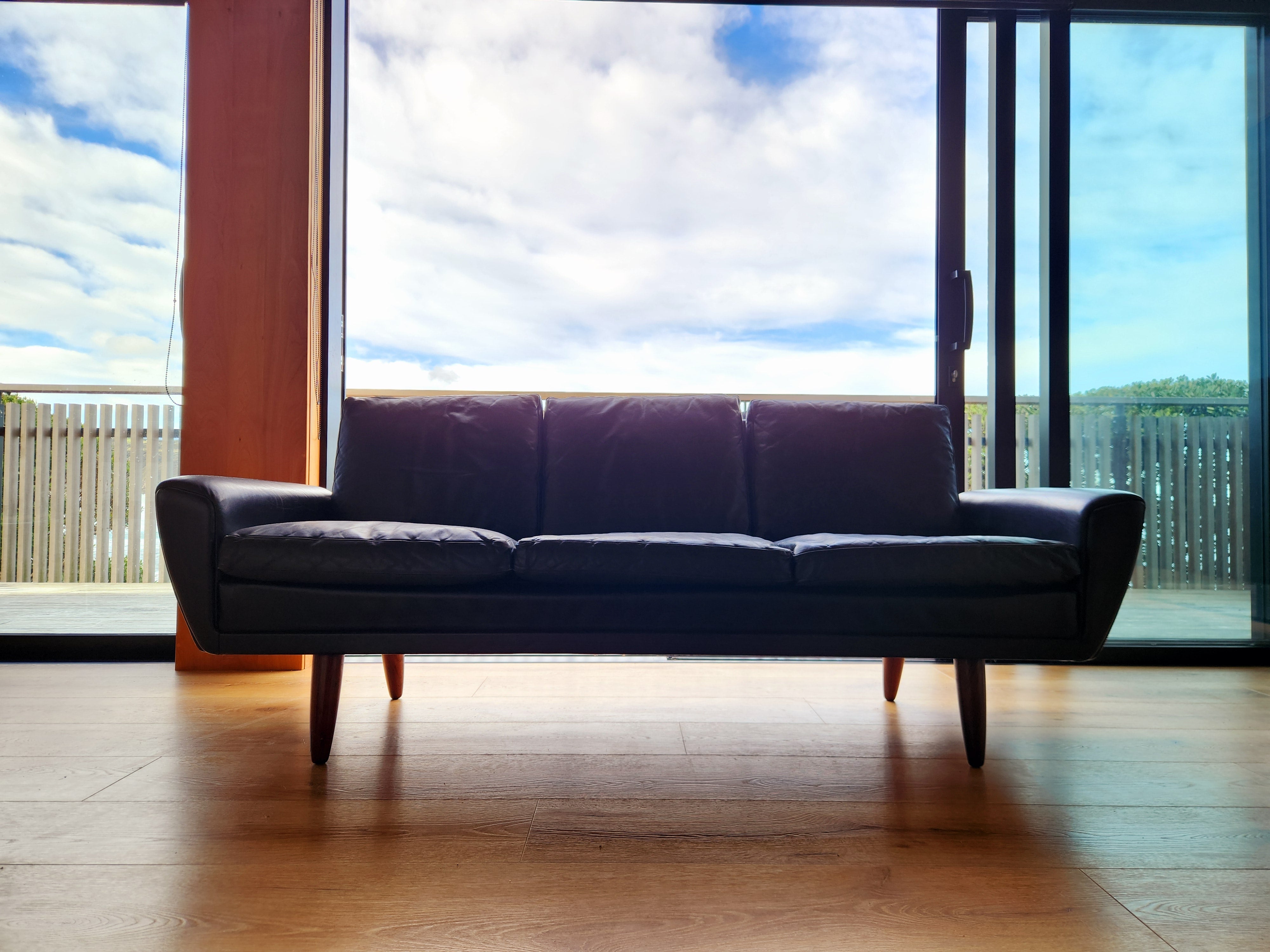 Danish mid century 3 seater sofa by Georg Thams in black leather and Rosewood legs. 