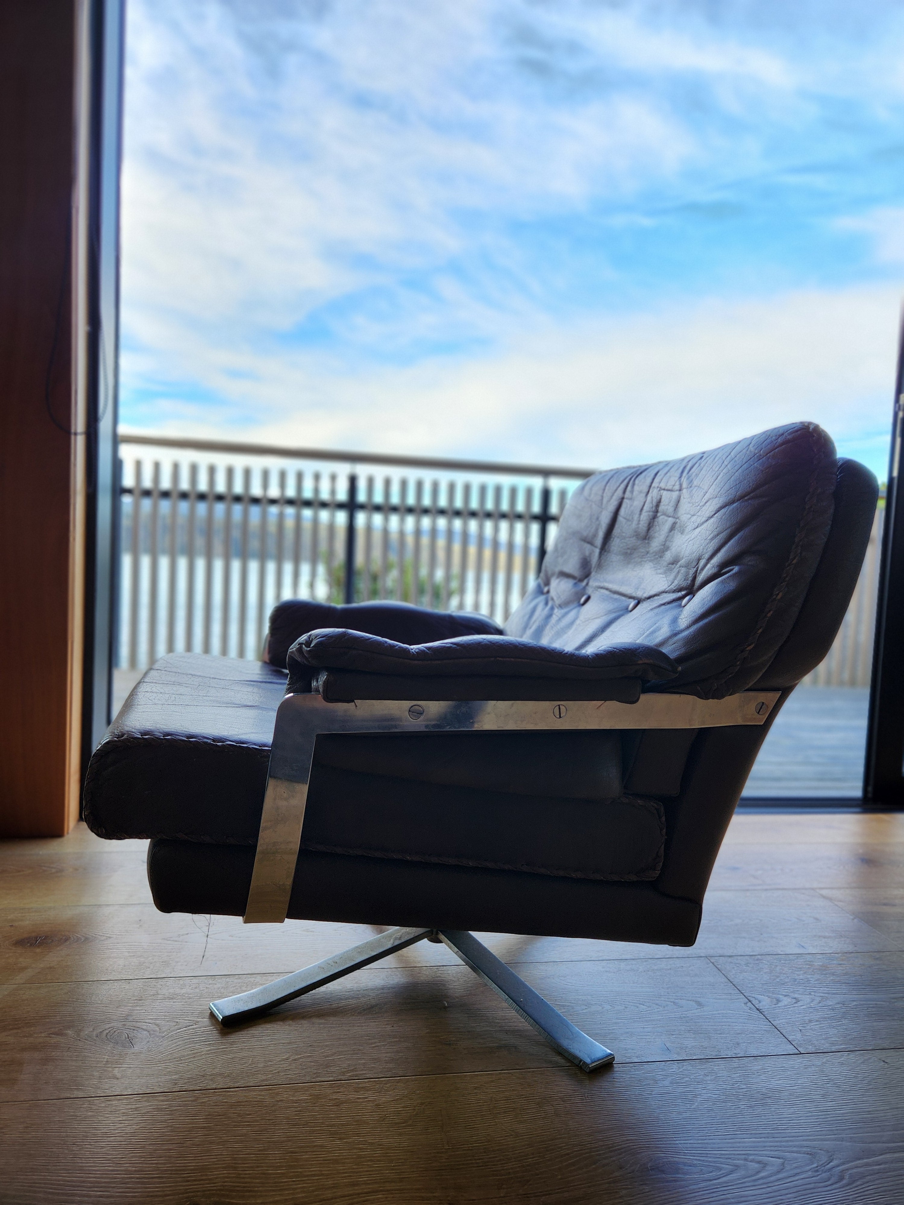 Mid Century Danish Swivel Armchair. Detail of the side particularly the chrome armrest.