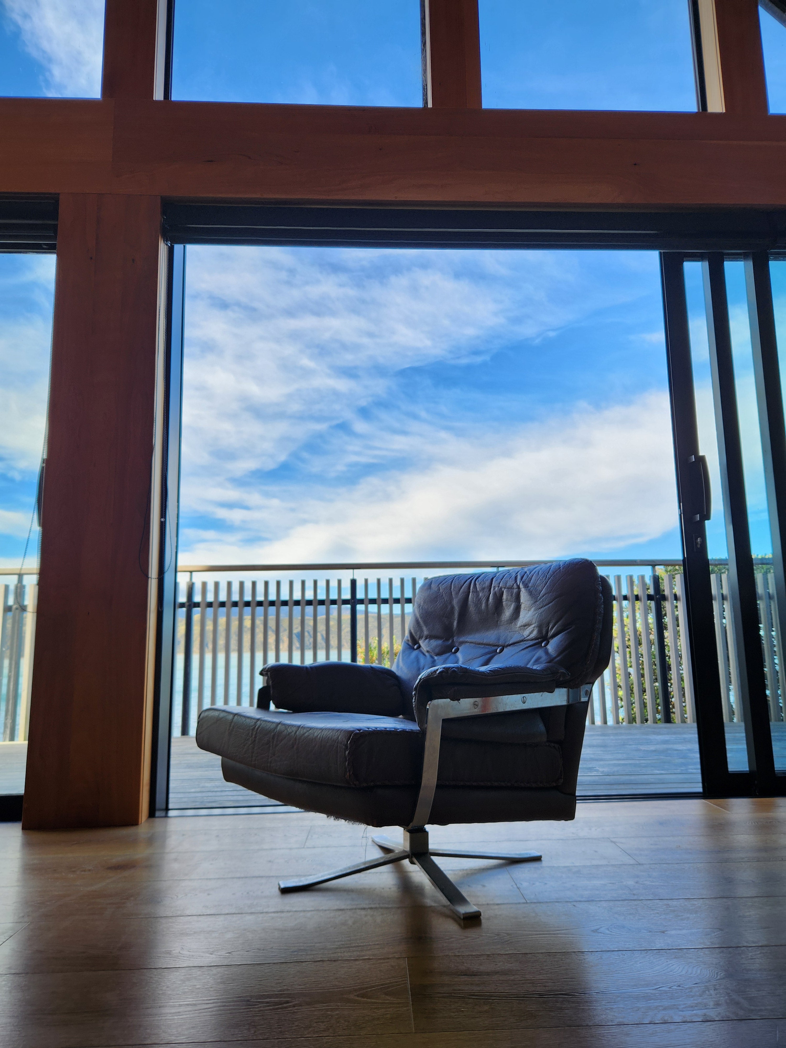 Mid Century Danish Swivel Armchair. A dramatic portrait view with interesting architectural backdrop.