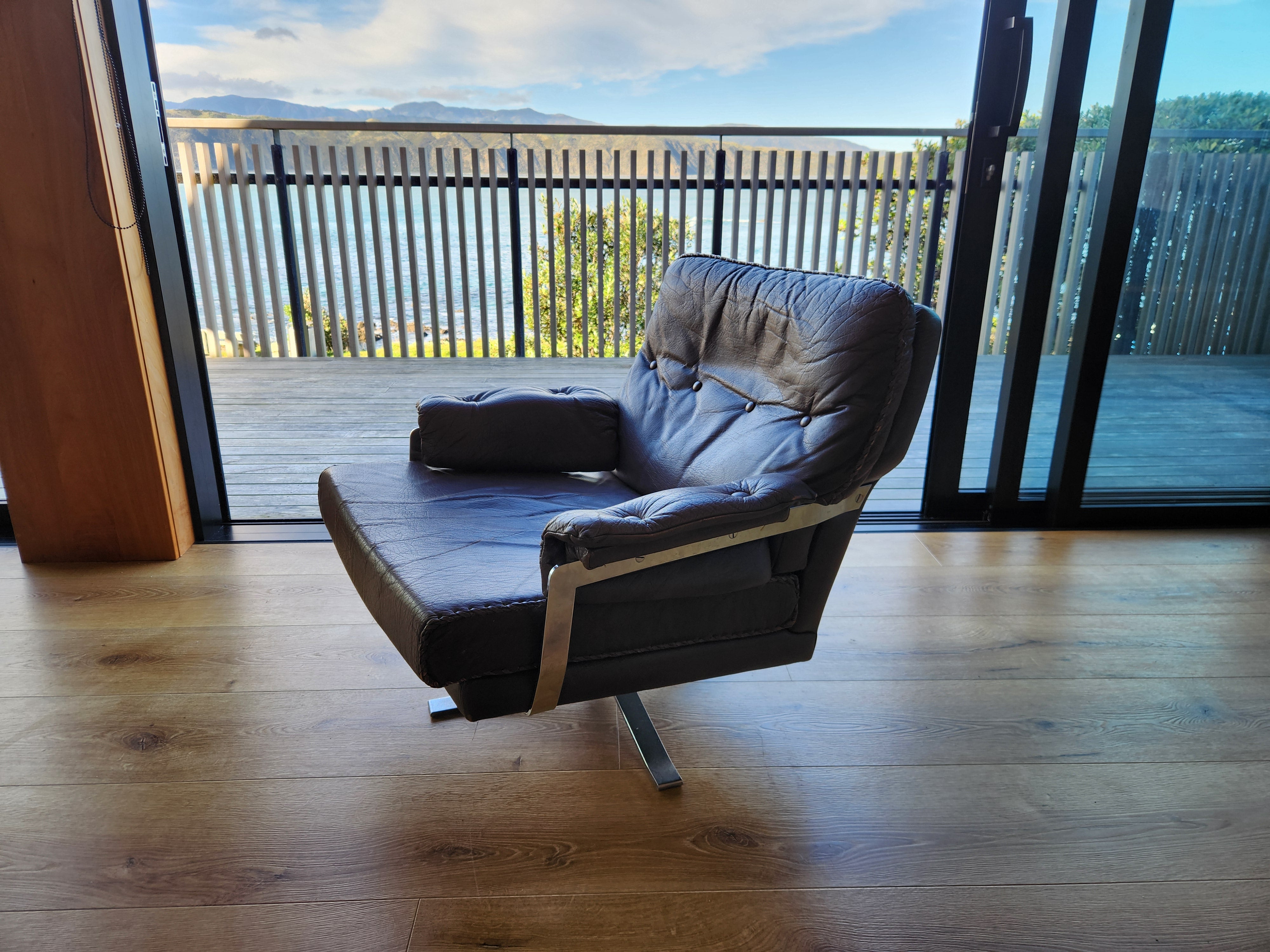 Mid Century Danish Swivel Armchair. viewed from above detailing the side, back, seat and chrome armrest. 