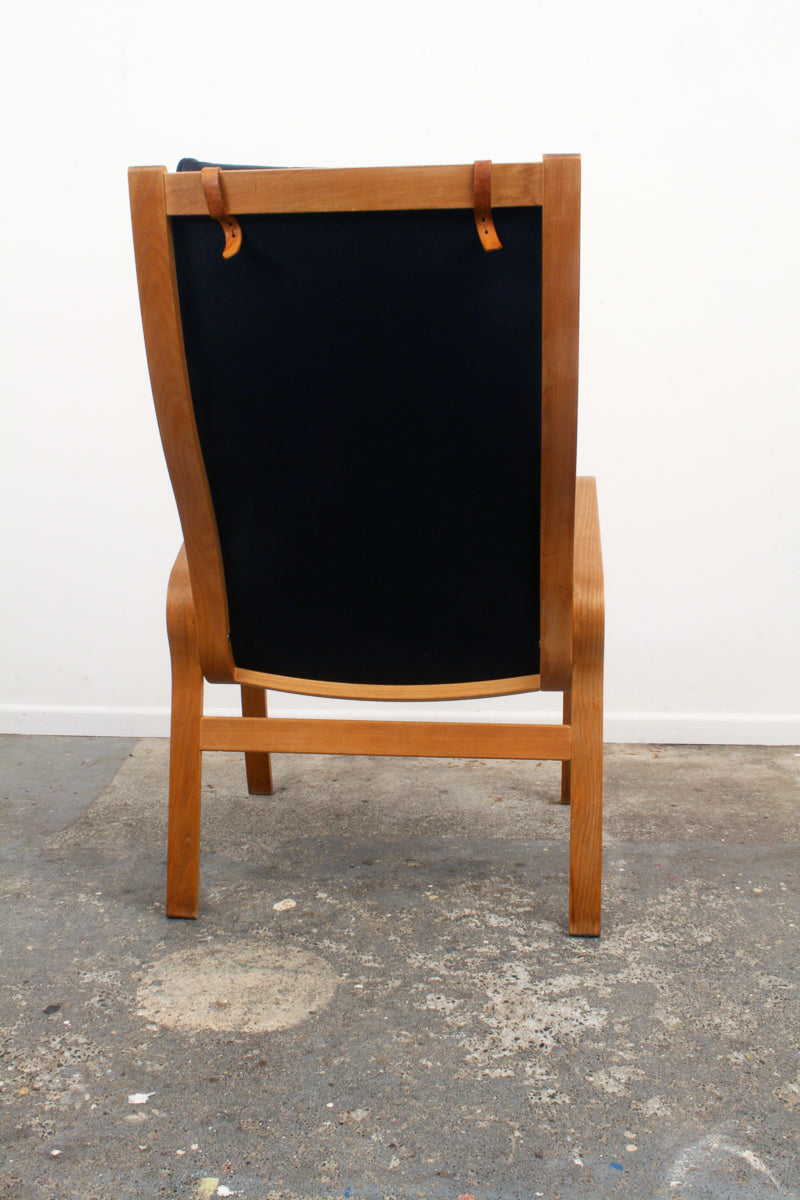 Danish Mid Century Armchair. Leather head cushion straps.