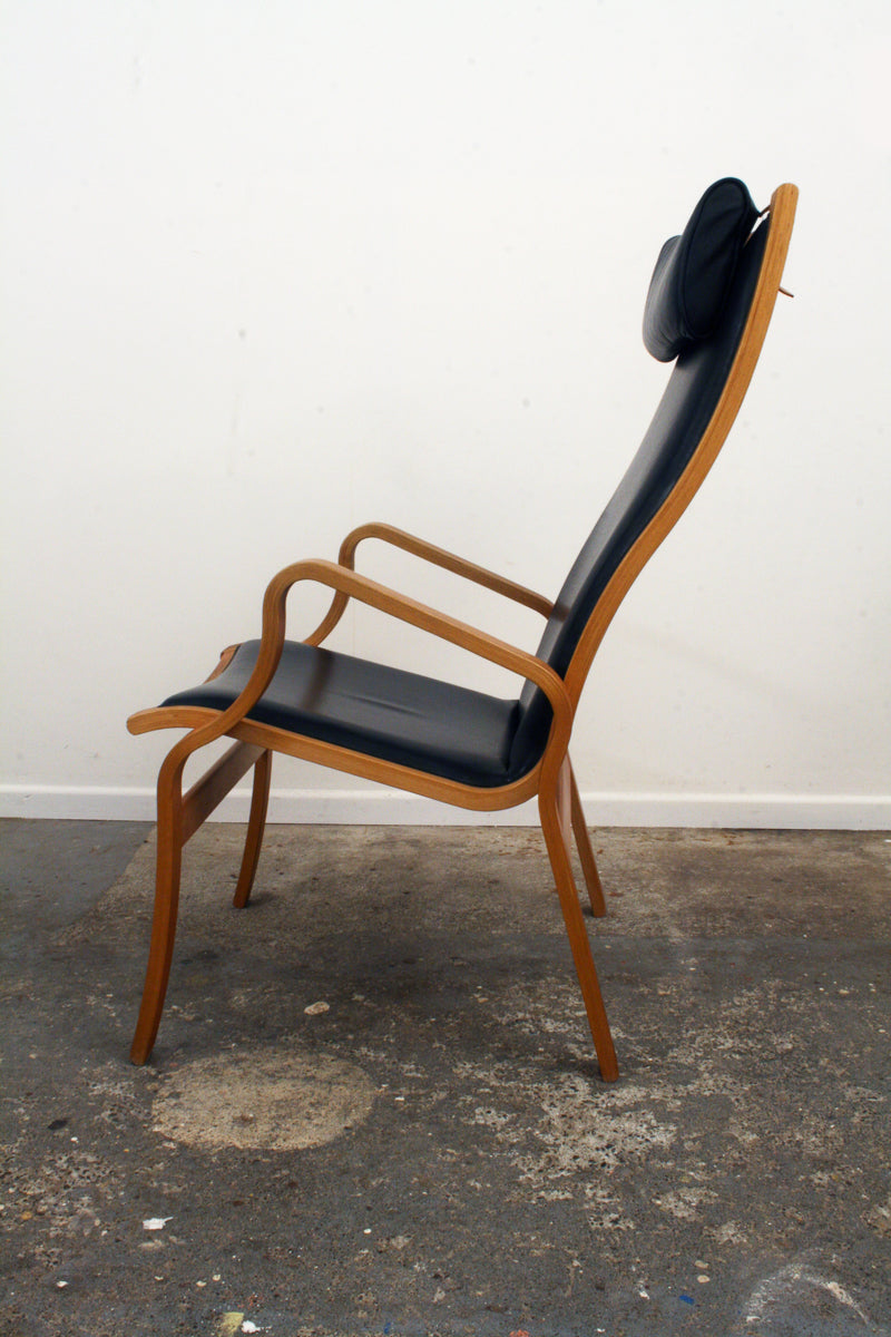 Danish Mid Century Armchair. Side view, Curved structure.