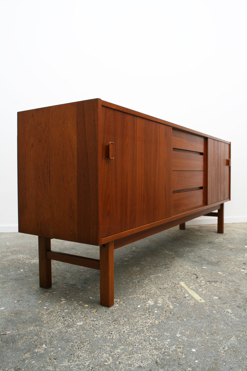 An isometric view of a mid century sideboard, Model 'Arild' by Nils Jonsson for Swedish manufacturer Troeds. Showing front and left end panel.  