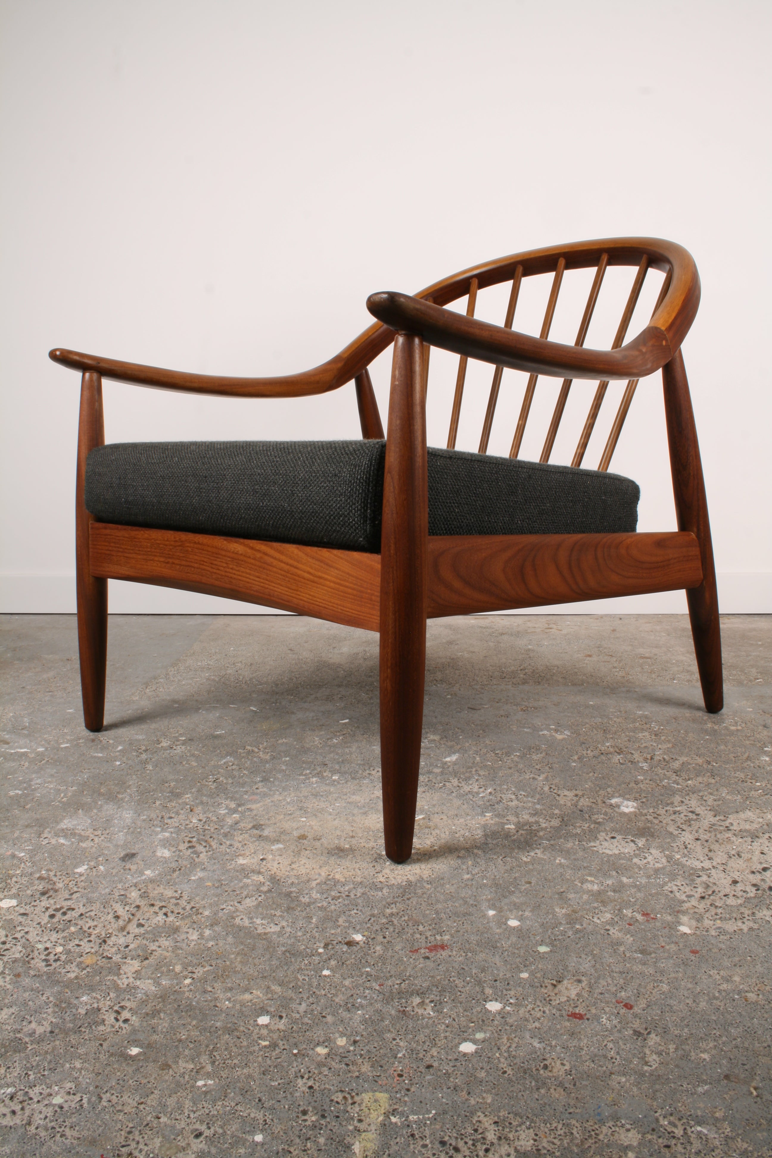 Mid Century Teak armchair with flowing curves.
