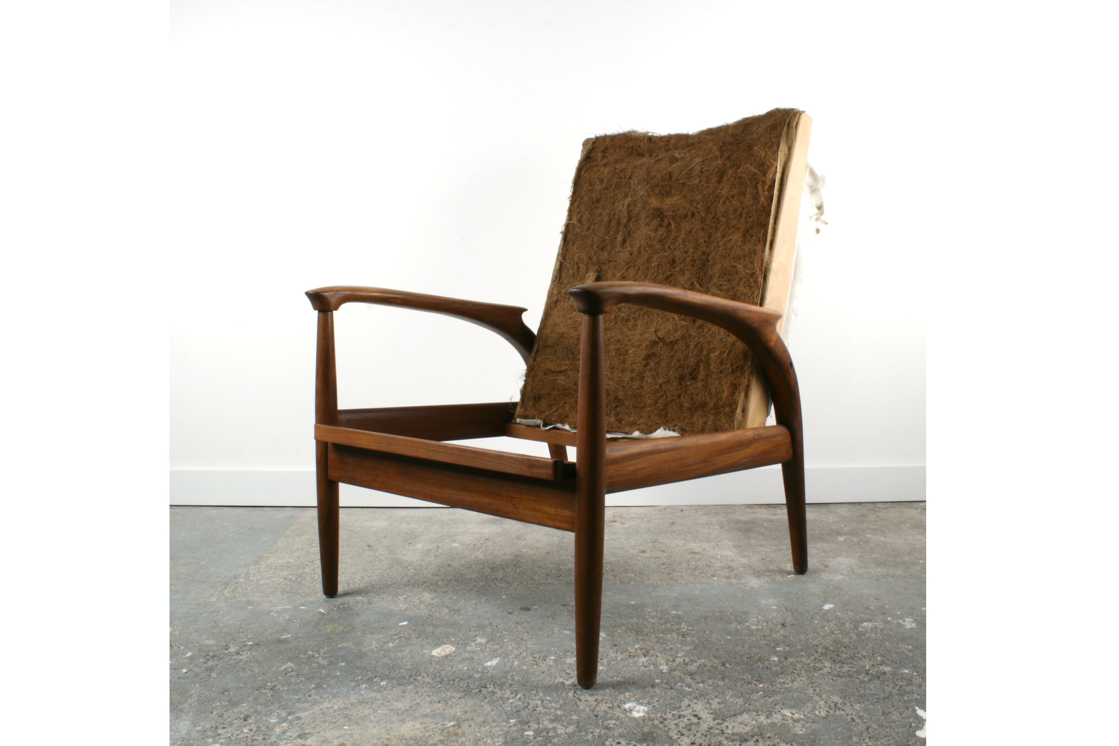An unrestored 1960's Greave and Thomas Teak armchair.