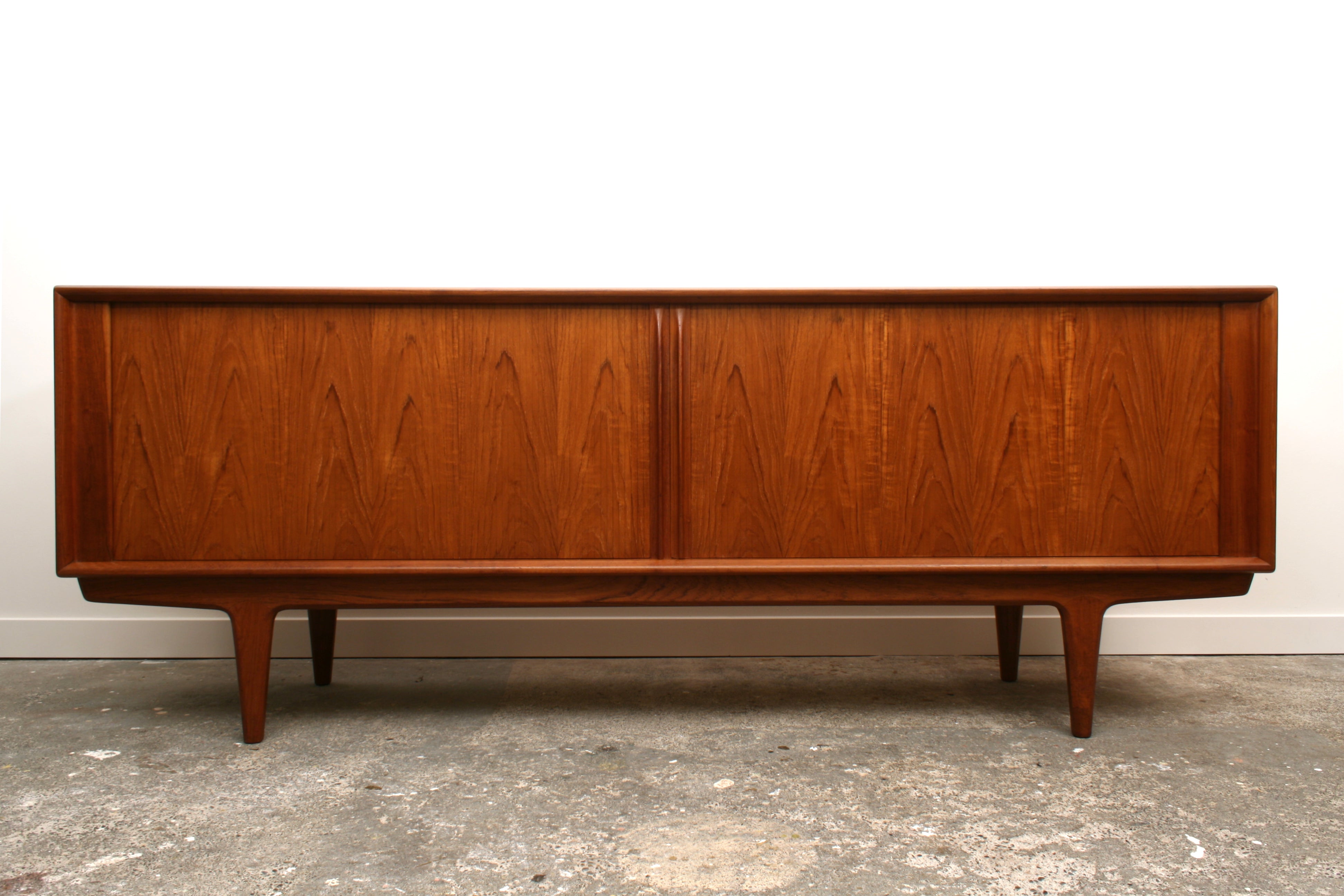 A Model 156 Danish Teak tambour sideboard by Bernhard Pedersen & Son. Shown from the front with doors closed.