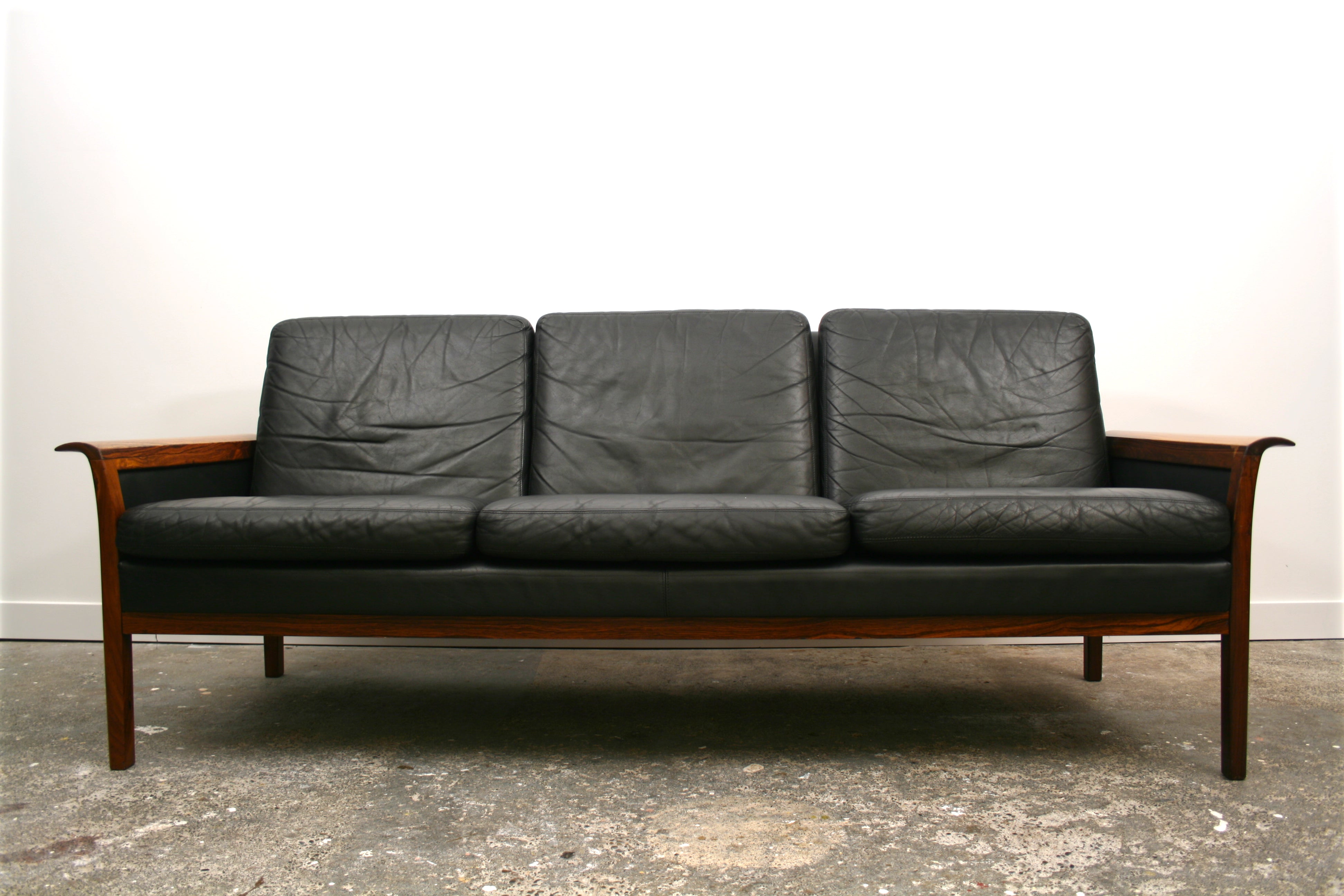 Mid Century Sofa. Solid Rosewood curved armrests.