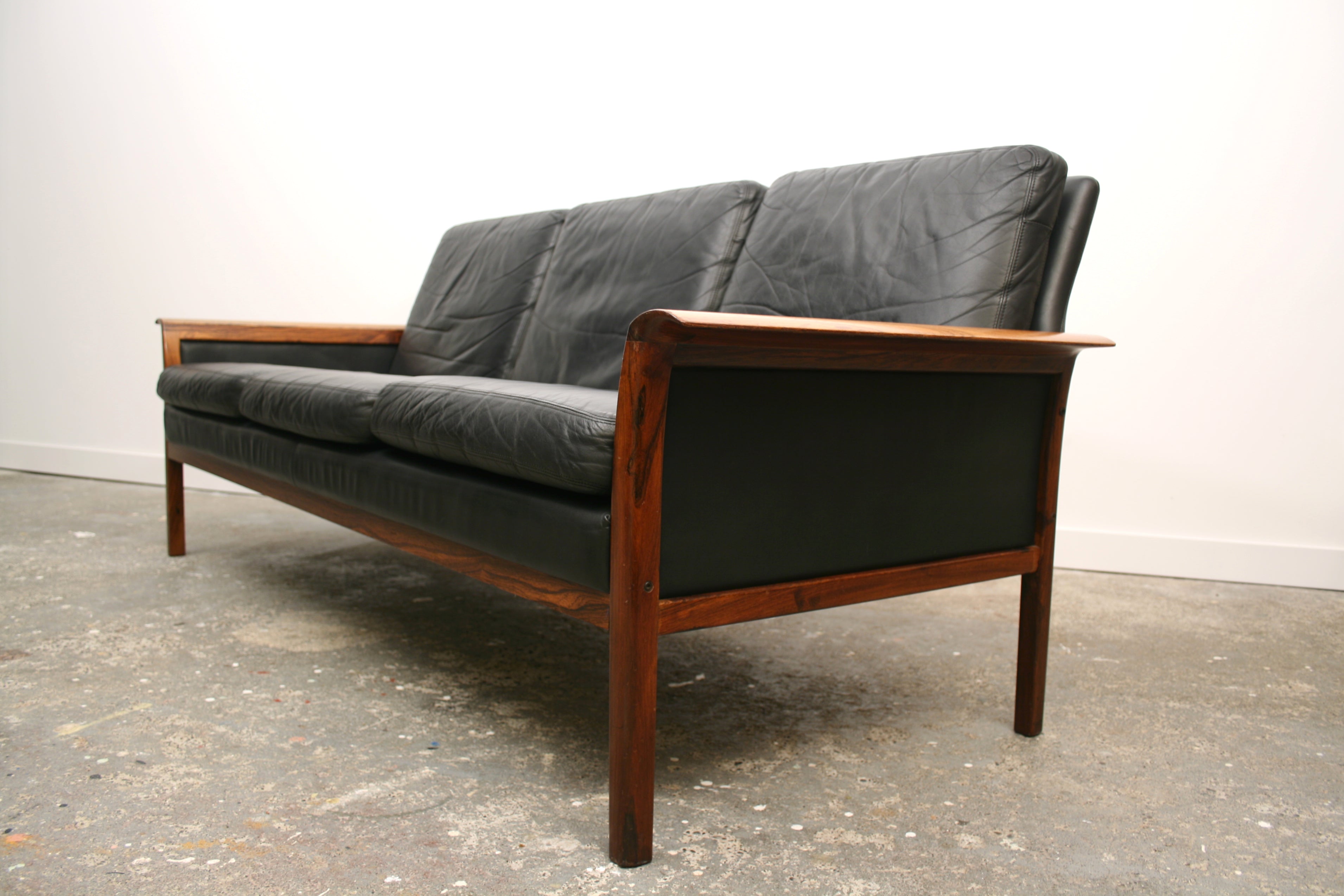 Norwegian Mid Century Sofa designed by Knut Saeter for Vatne Mobler. In Rosewood and black leather.