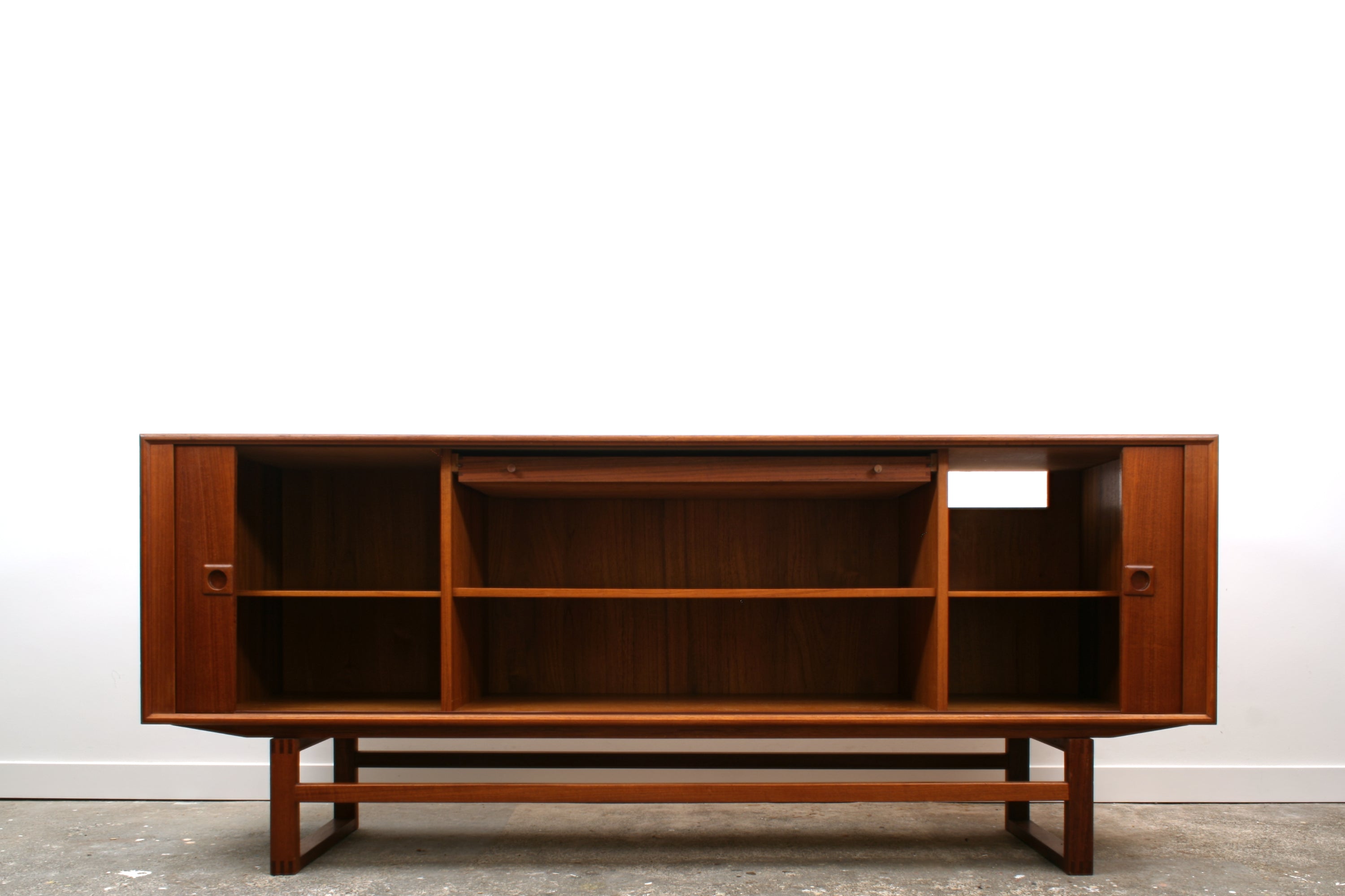 Danish Tambour sideboard by Axel Christensen Odder. Shown in Teak with doors open. .Revealing a large central bay with shelf and slim drawer. Flanked by two small bays with adjustable 