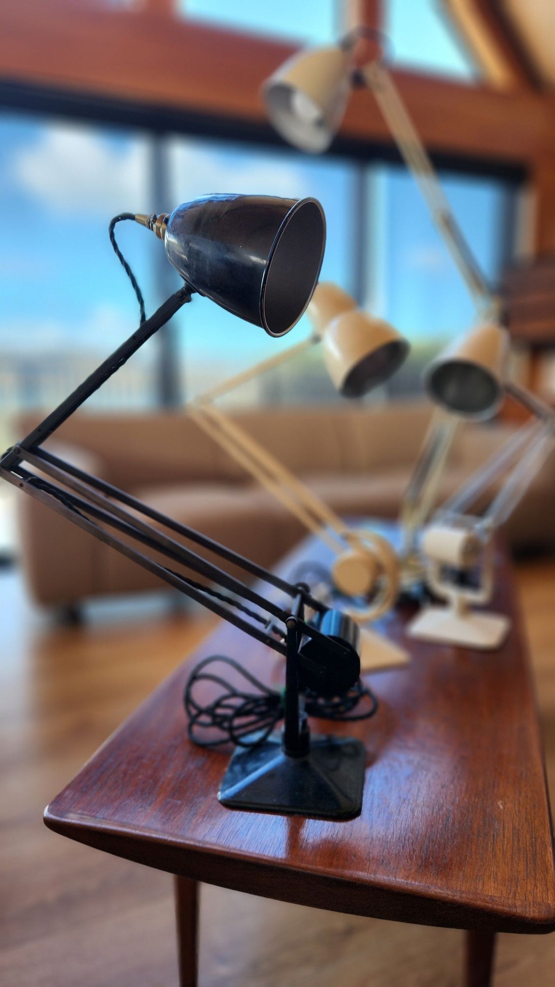 Group of old anglepoise lamps on coffee table.