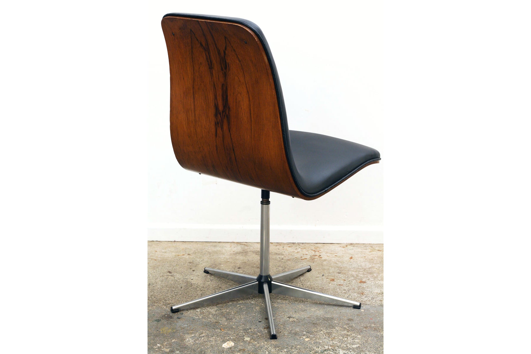 Rosewood Mid century swivel chairs showing curved structure.