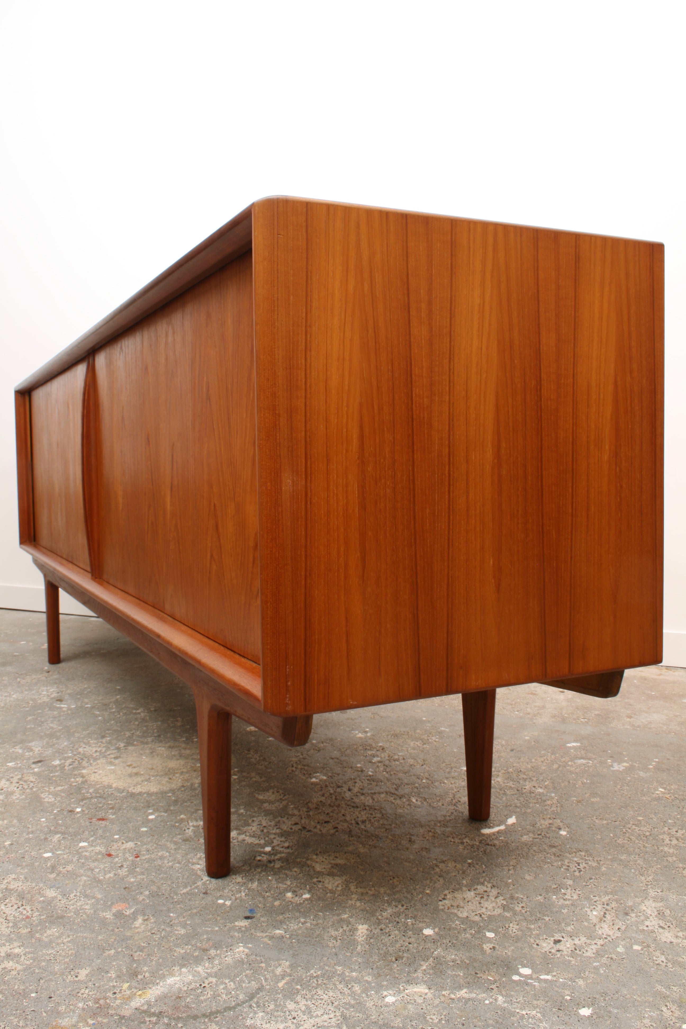 Danish Teak Tambour sideboard acute angle along length highlighting minimalist sculpture.