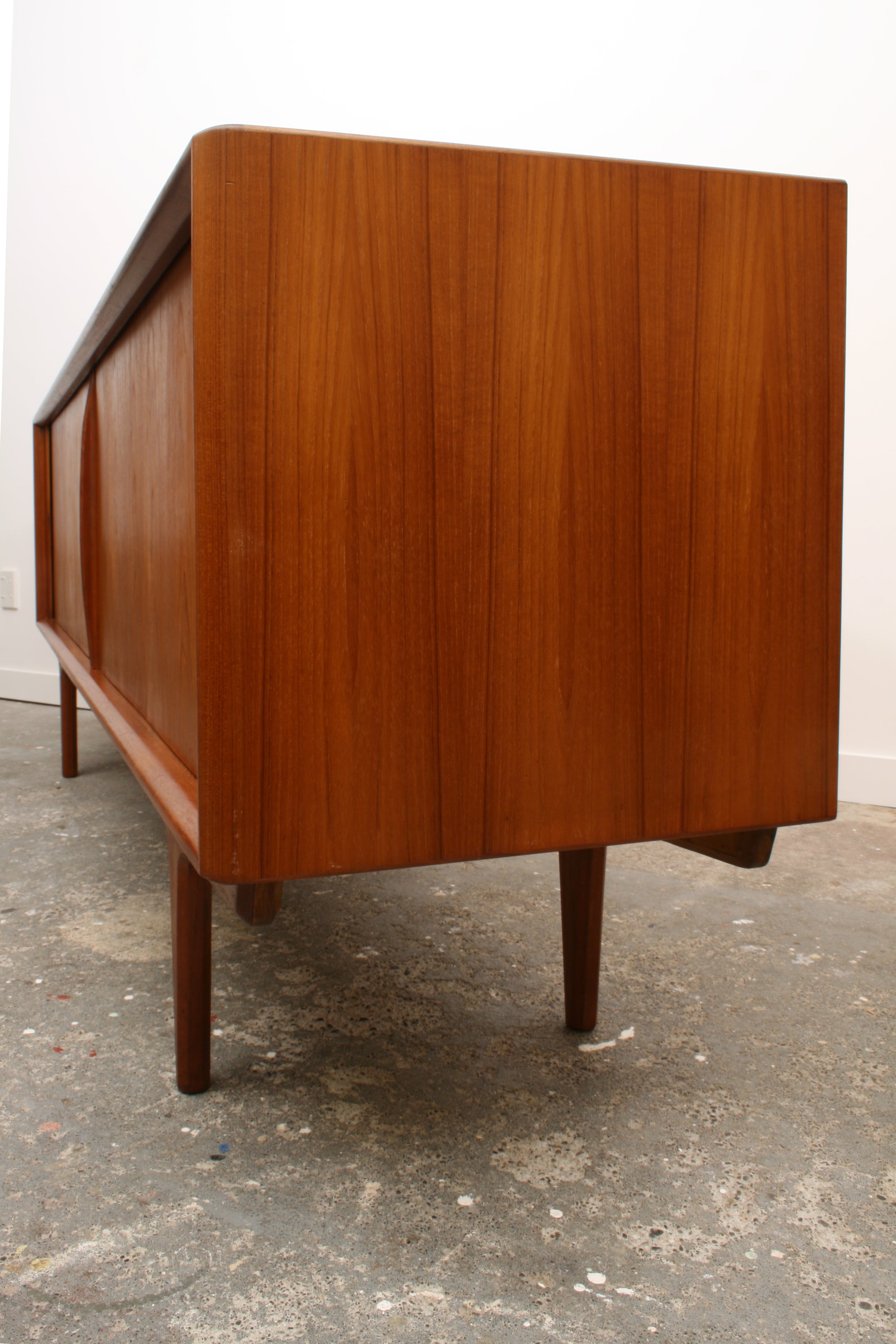 Danish Teak Tambour sideboard oblique view showing end panels straight teak grain.