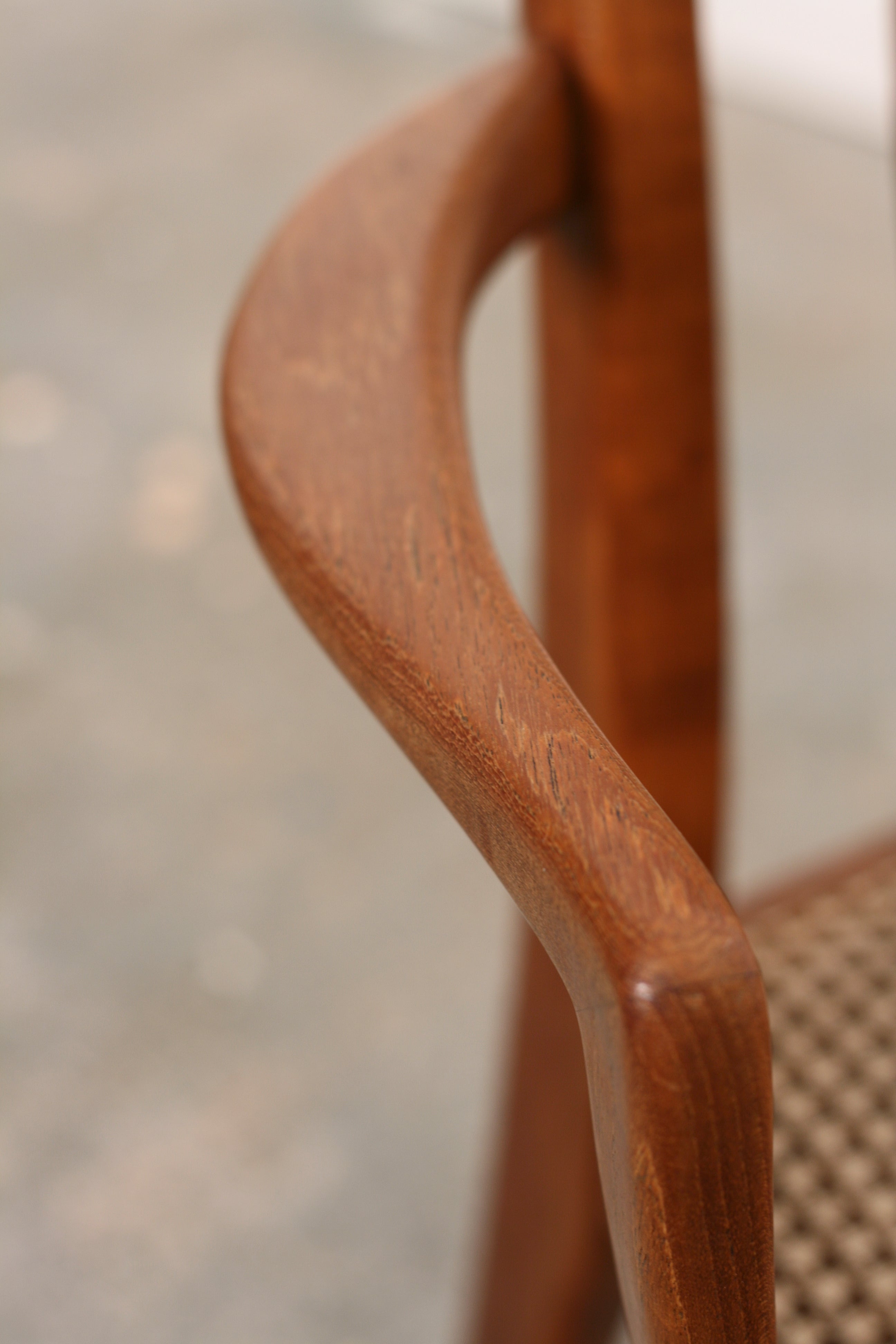 Danish mid century teak carvers close up arm detail.