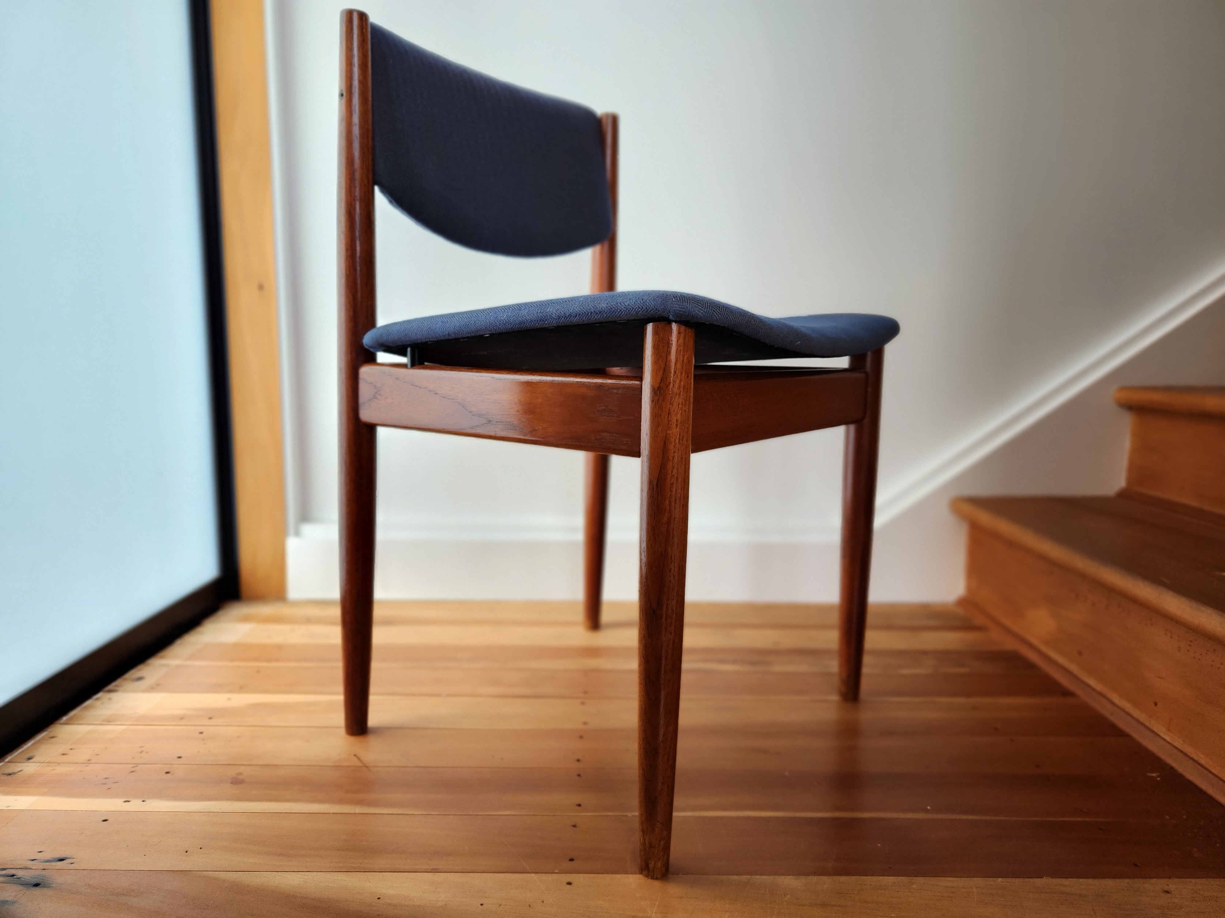 Danish modern dining chair showing floating seat detail.
