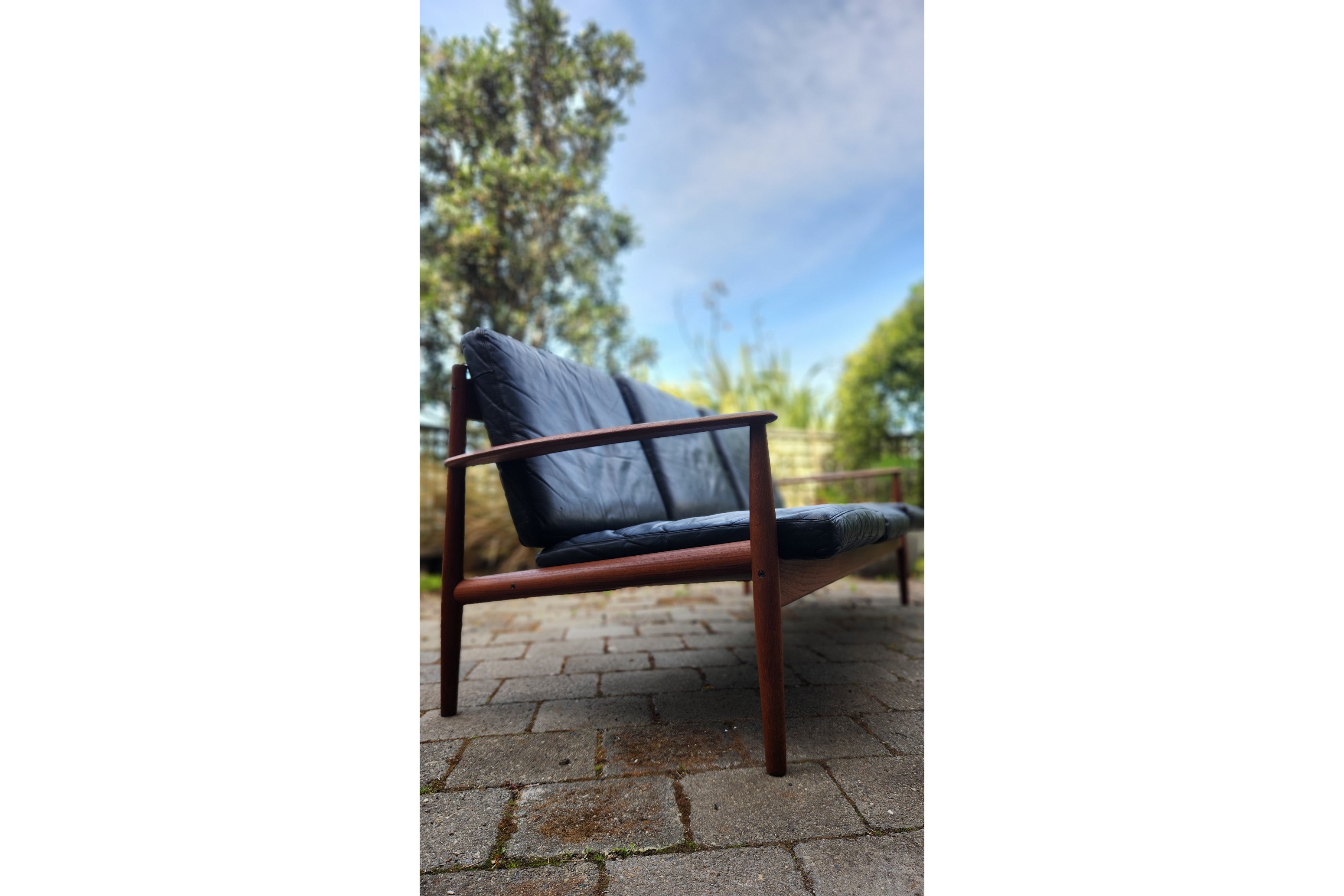 Gete Jalk model 118 sofa in Teak shown with leather cushions.