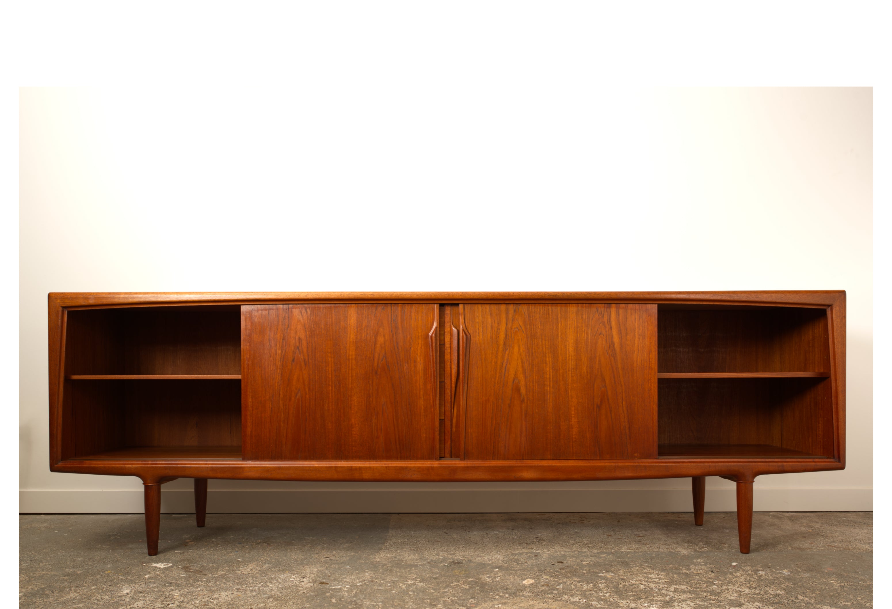 Teak Danish sideboard by Gunni Omann. Seen from the front with the outer doorsslid open.