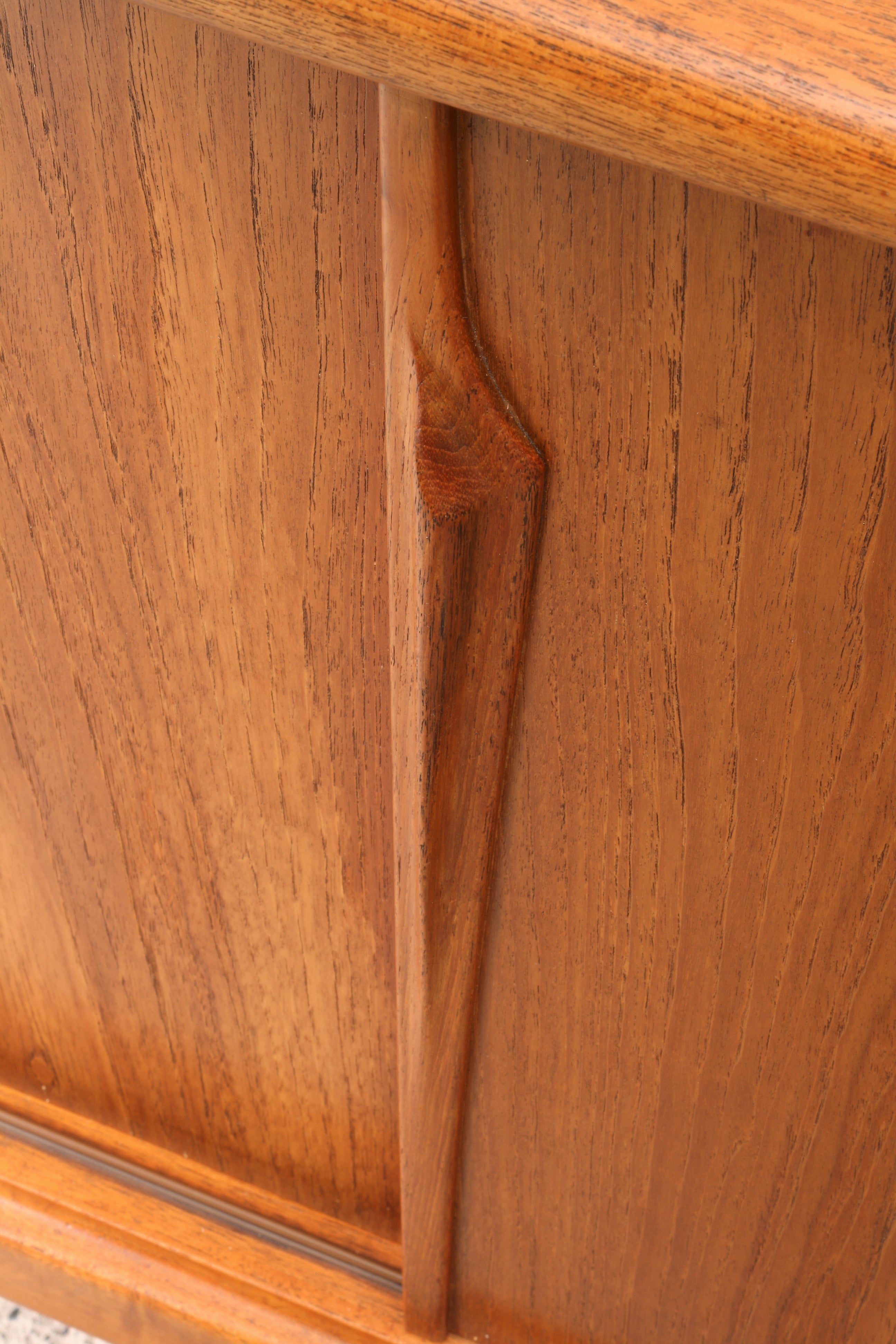 Danish teak sideboard close up of door handle moulding.