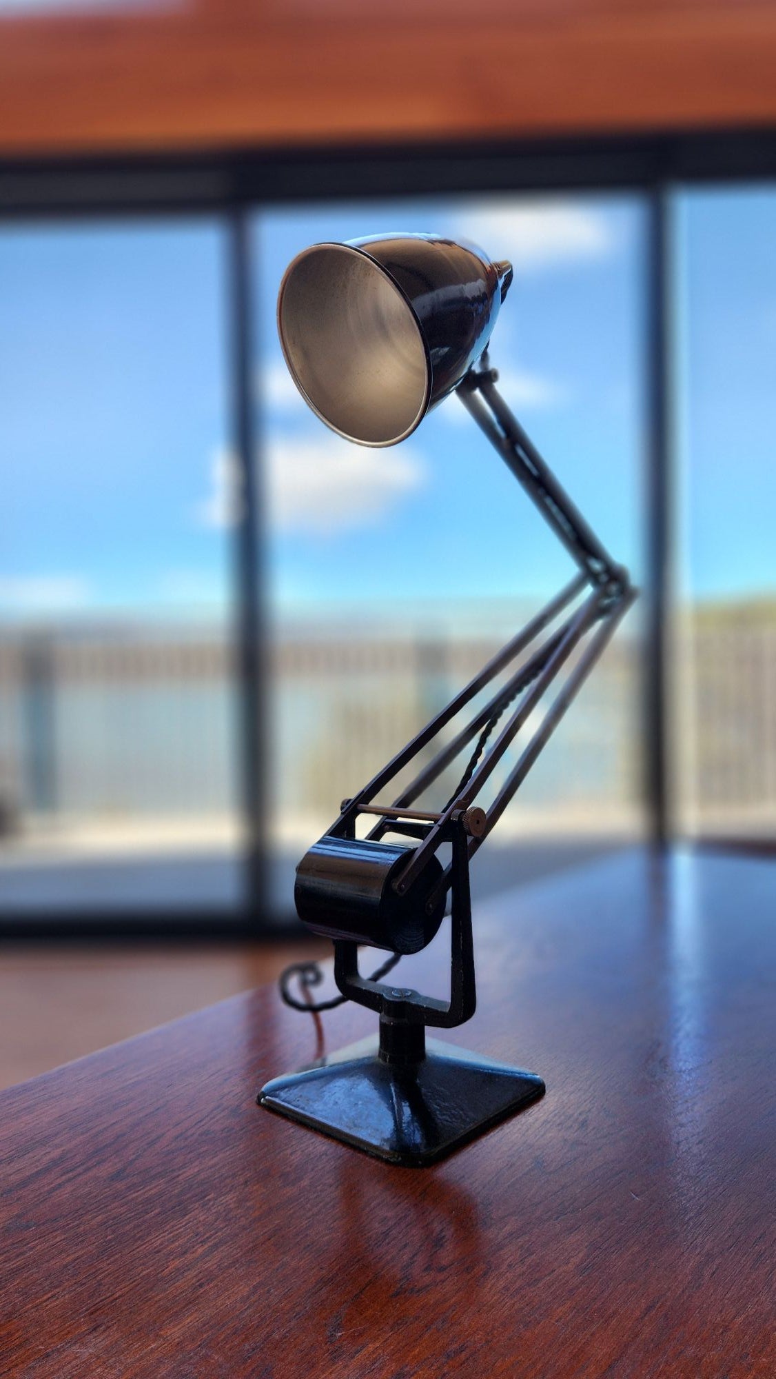 Black old Hadrill and Horstmann anglepoise lamp. front view in potrait.