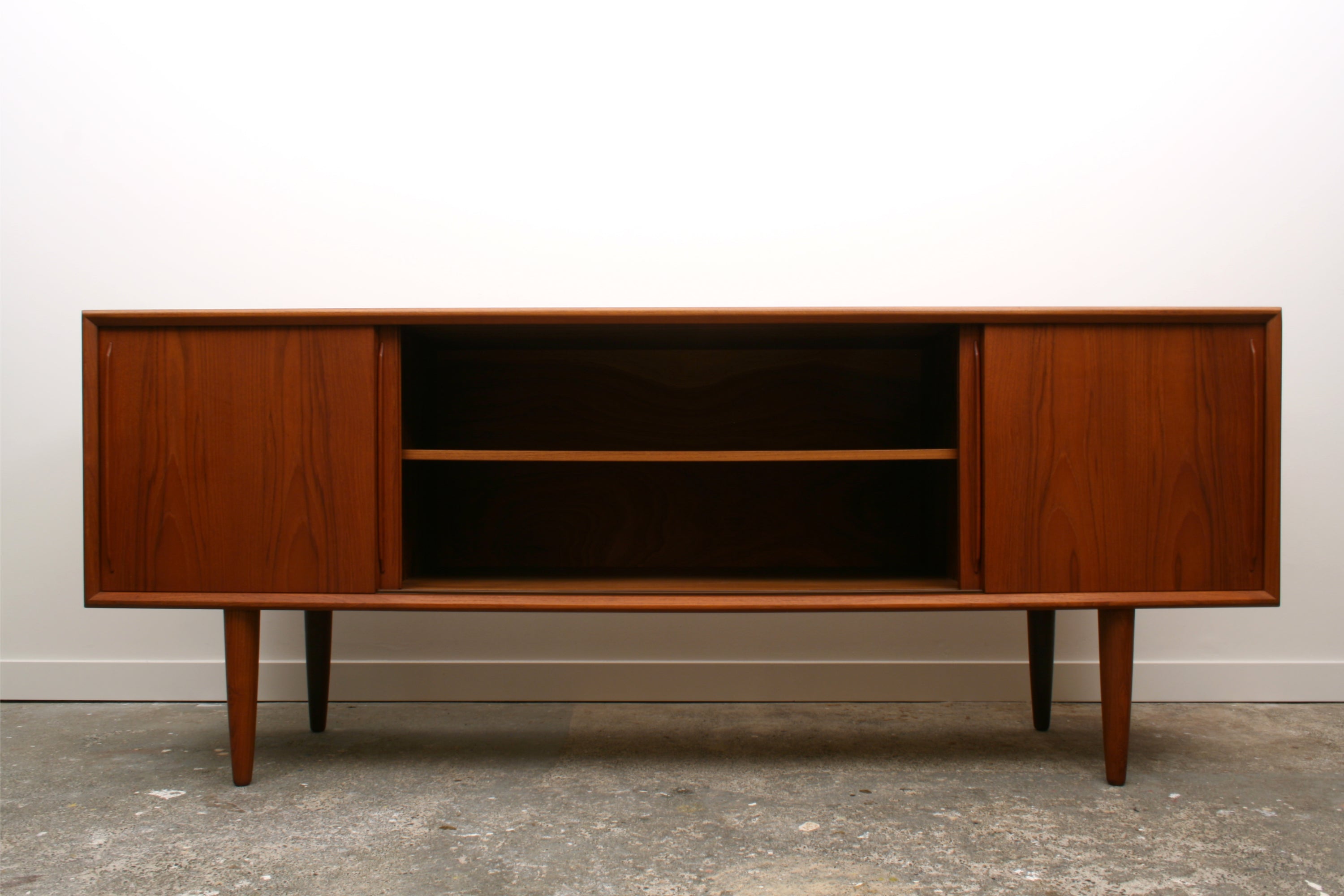 Danish Teak Mid Century Sideboard by H P Hansen. With central doors slid open to reveal a double width cupboard with adjustable shelf.