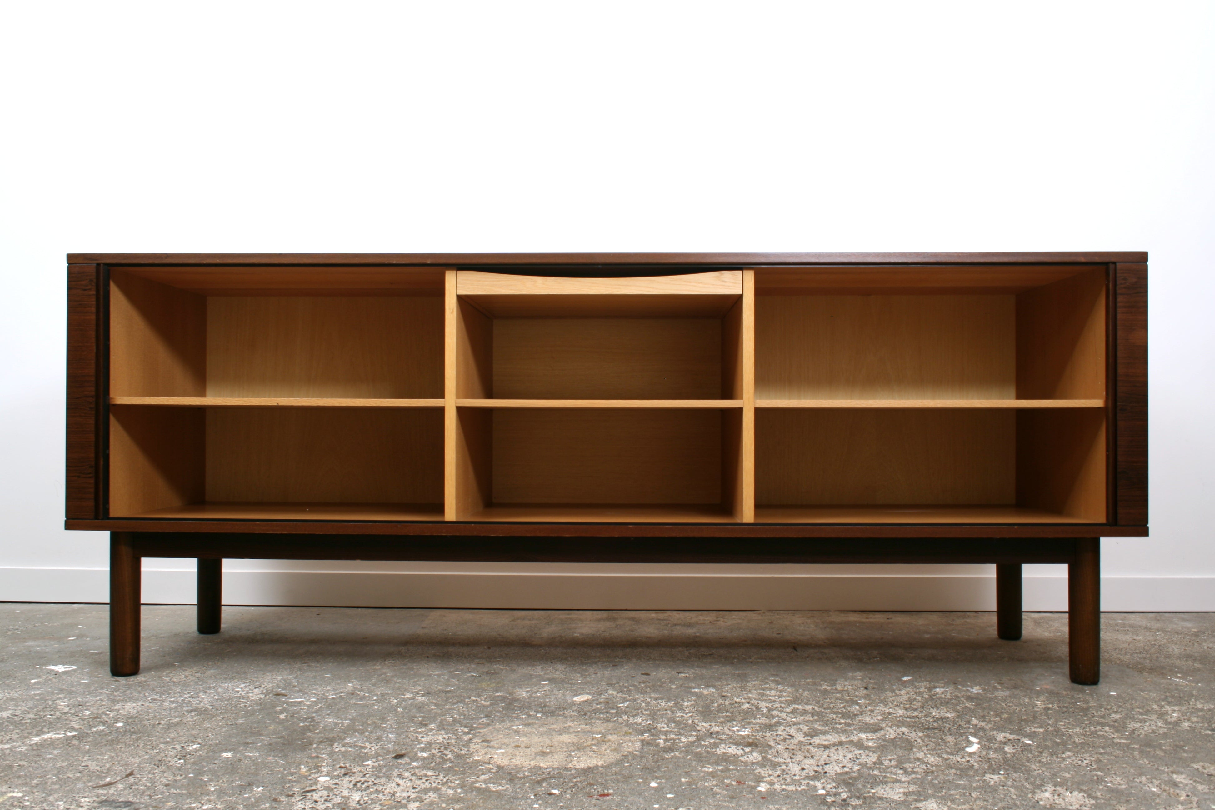 Danish Tambour sideboard by Hornslet Mobelfabrik. With doors open revealing the light interior in Oak and Maple. With three adjustable shelves and a shallow drawer. 