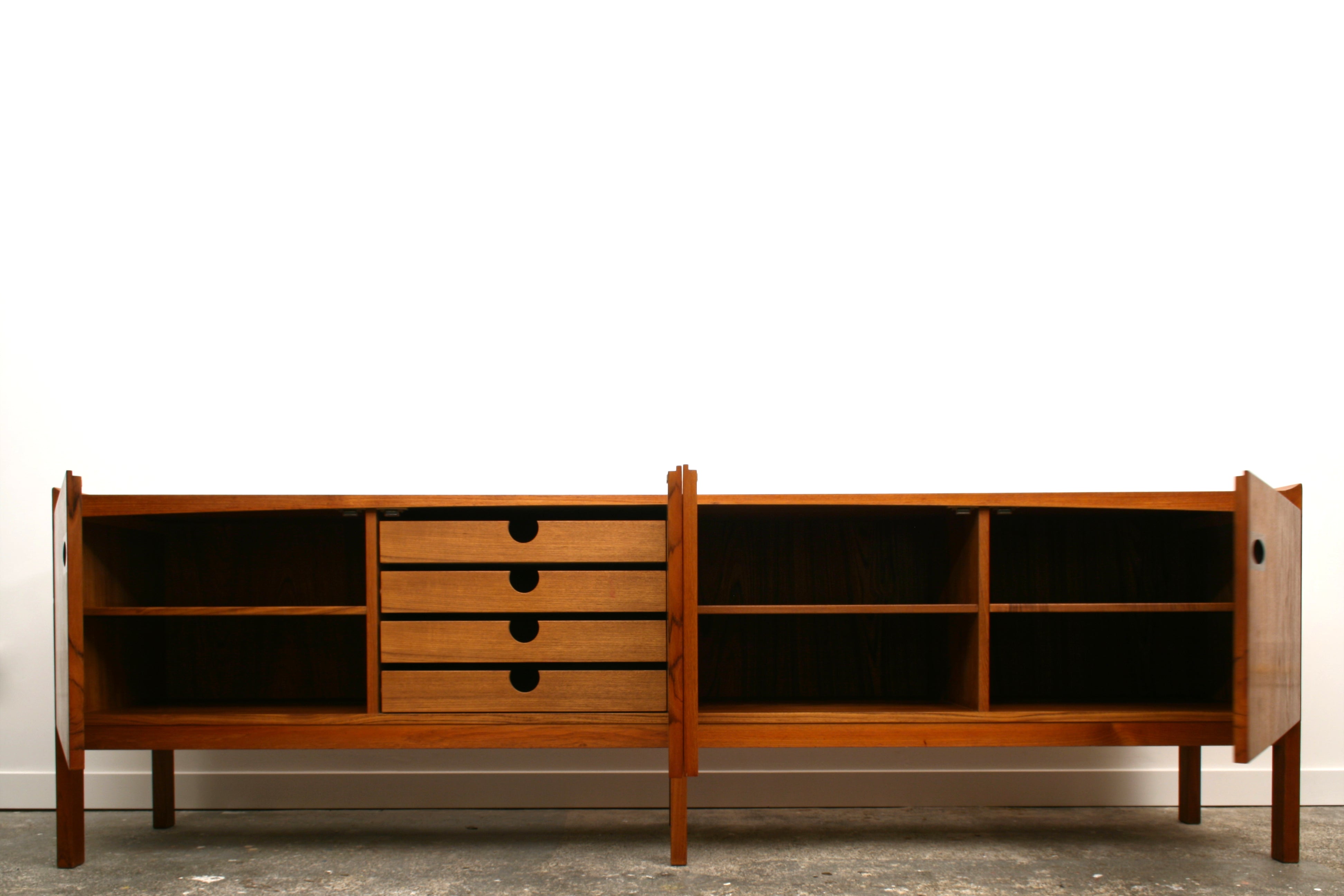 mid century sideboard with doors open showing internal storage detail and capacity.