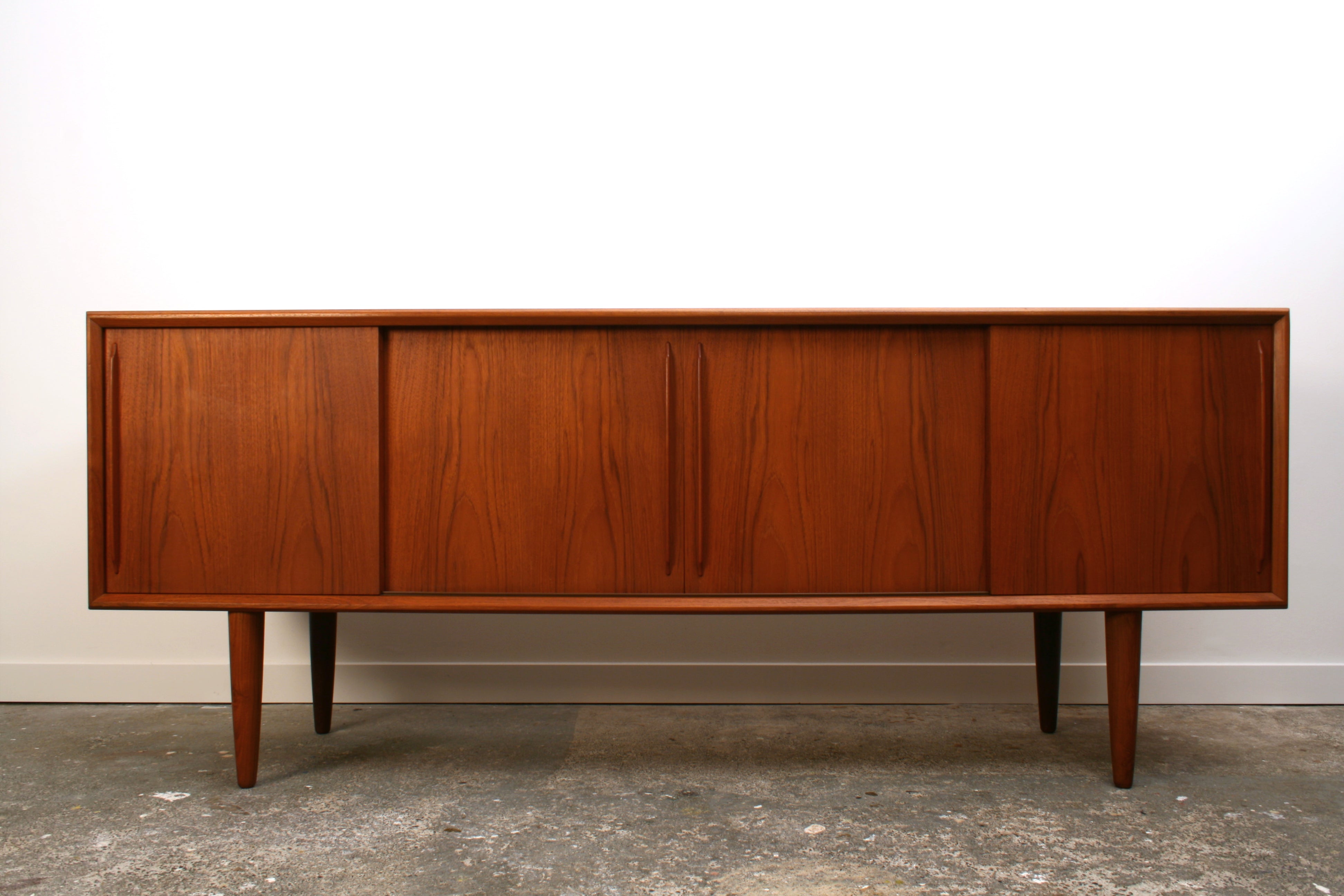 Danish Teak Mid Century Sideboard by H P Hansen. With four sliding doors and book matched veneers.