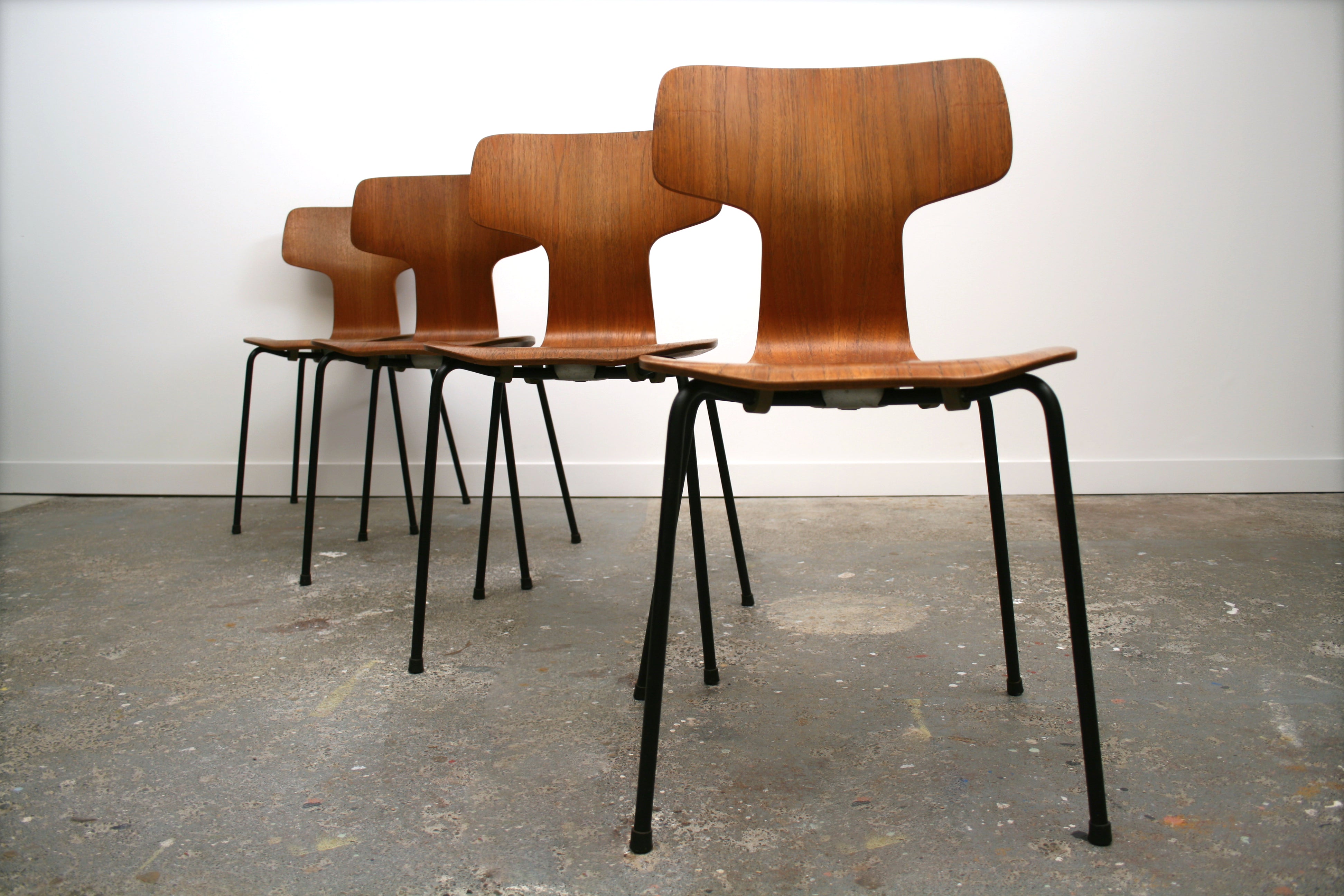 Teak Mid Century Dining Chairs. Four in a row showing off sculptural presence. 