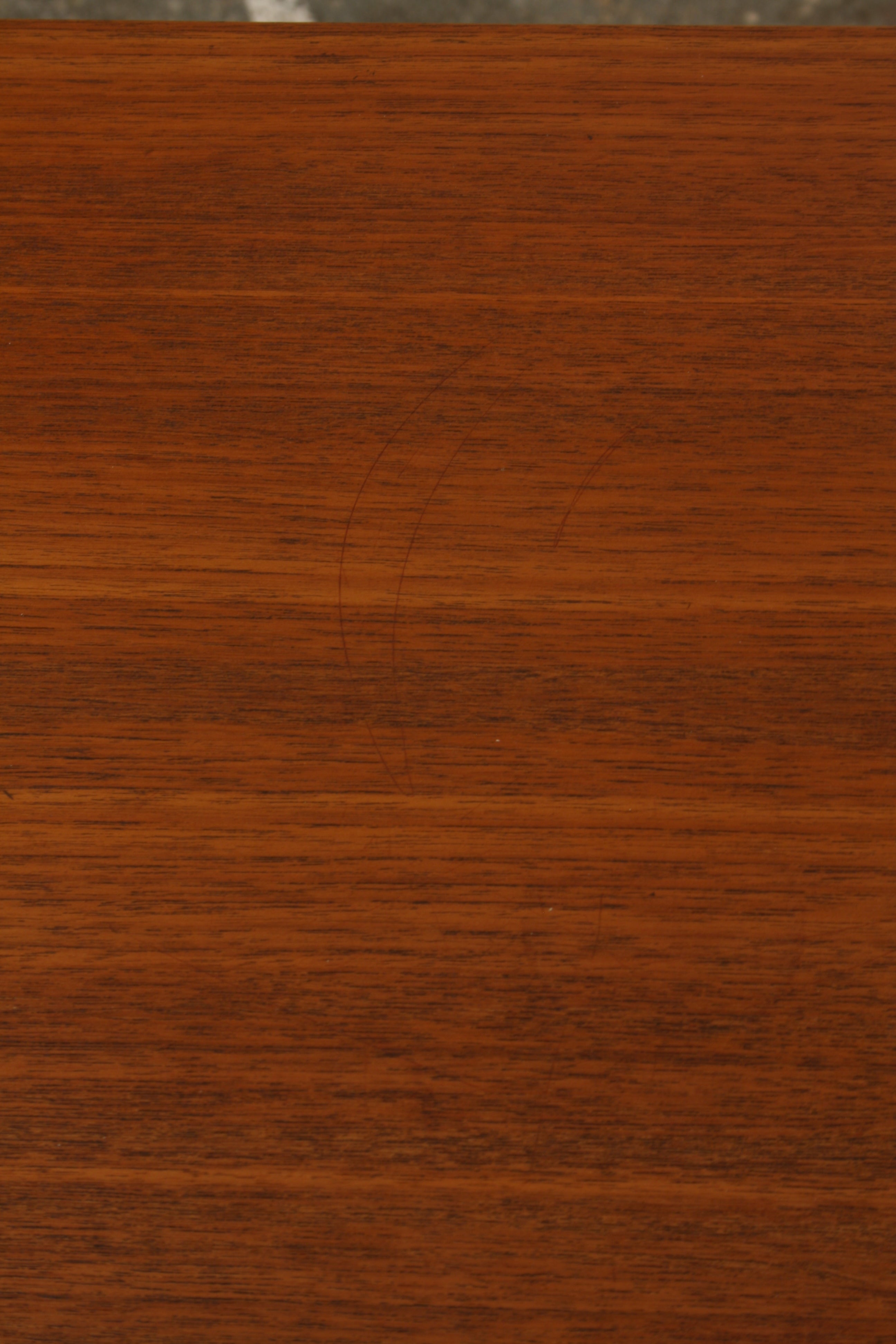 Norwegian teak sideboard close up of top showing faint light marking.