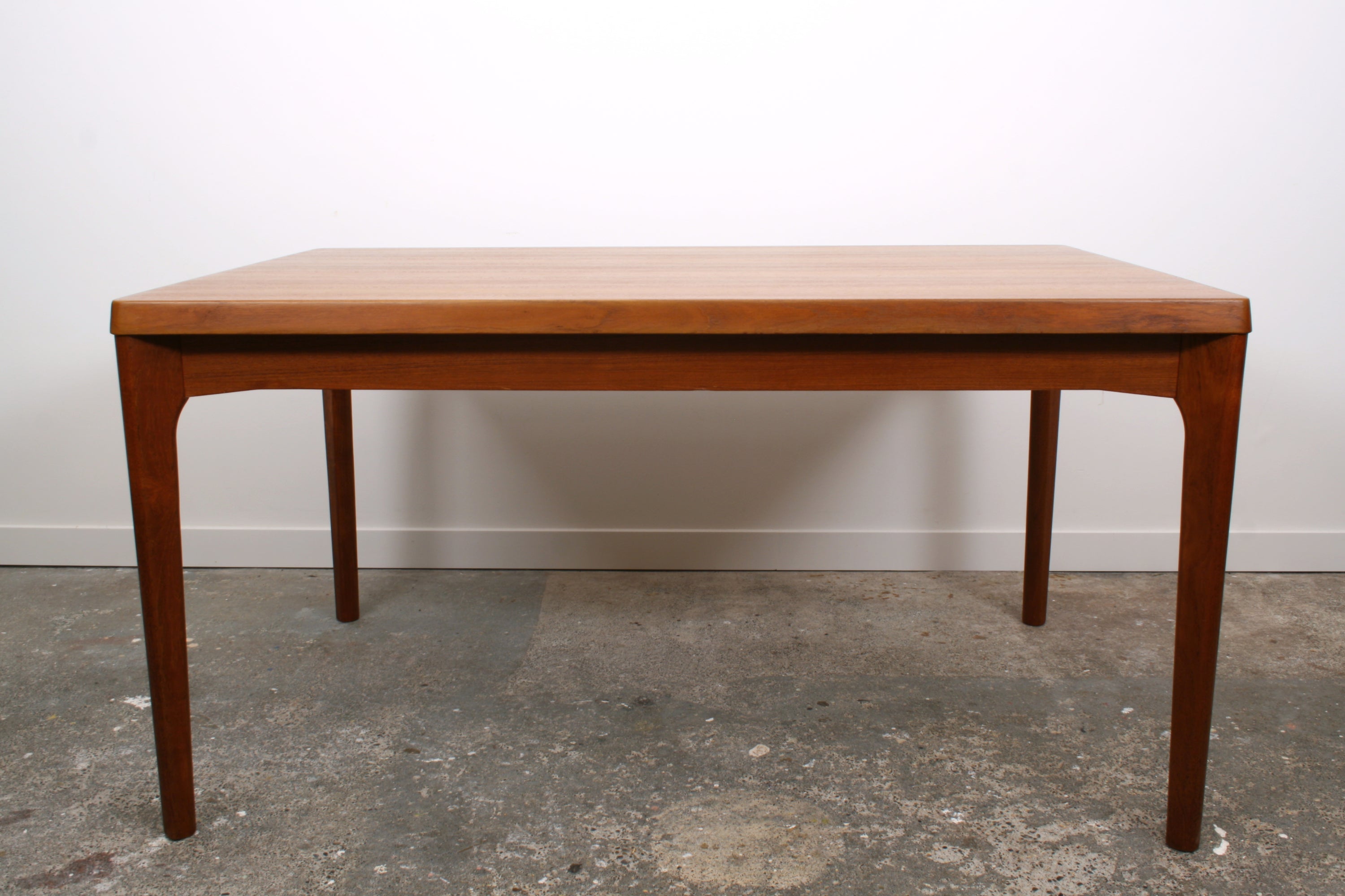 Henning Kjaernulf Danish Dining Table. Viewed in profile.
