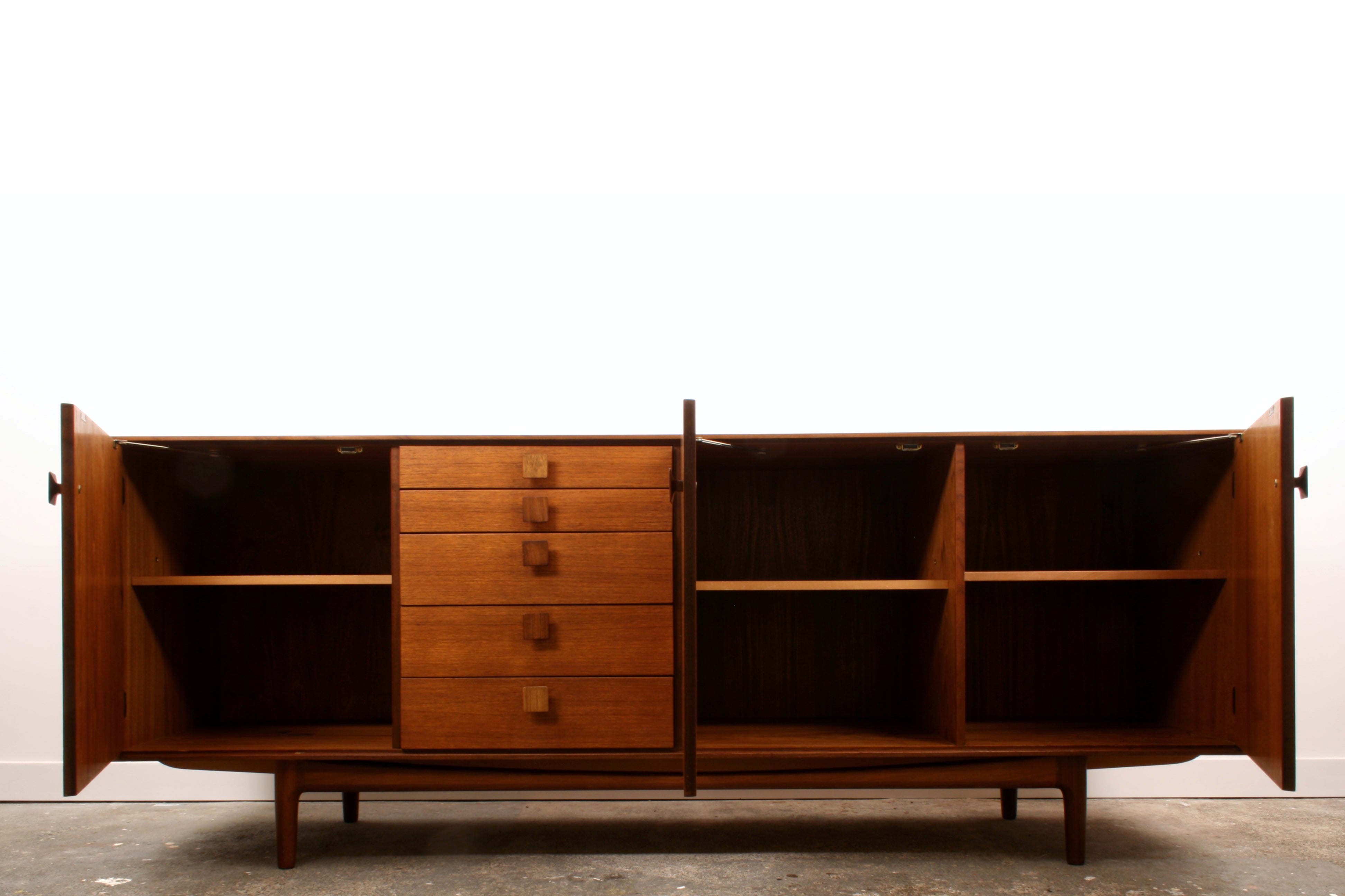 Mid Century teak sideboard shown with doors open.