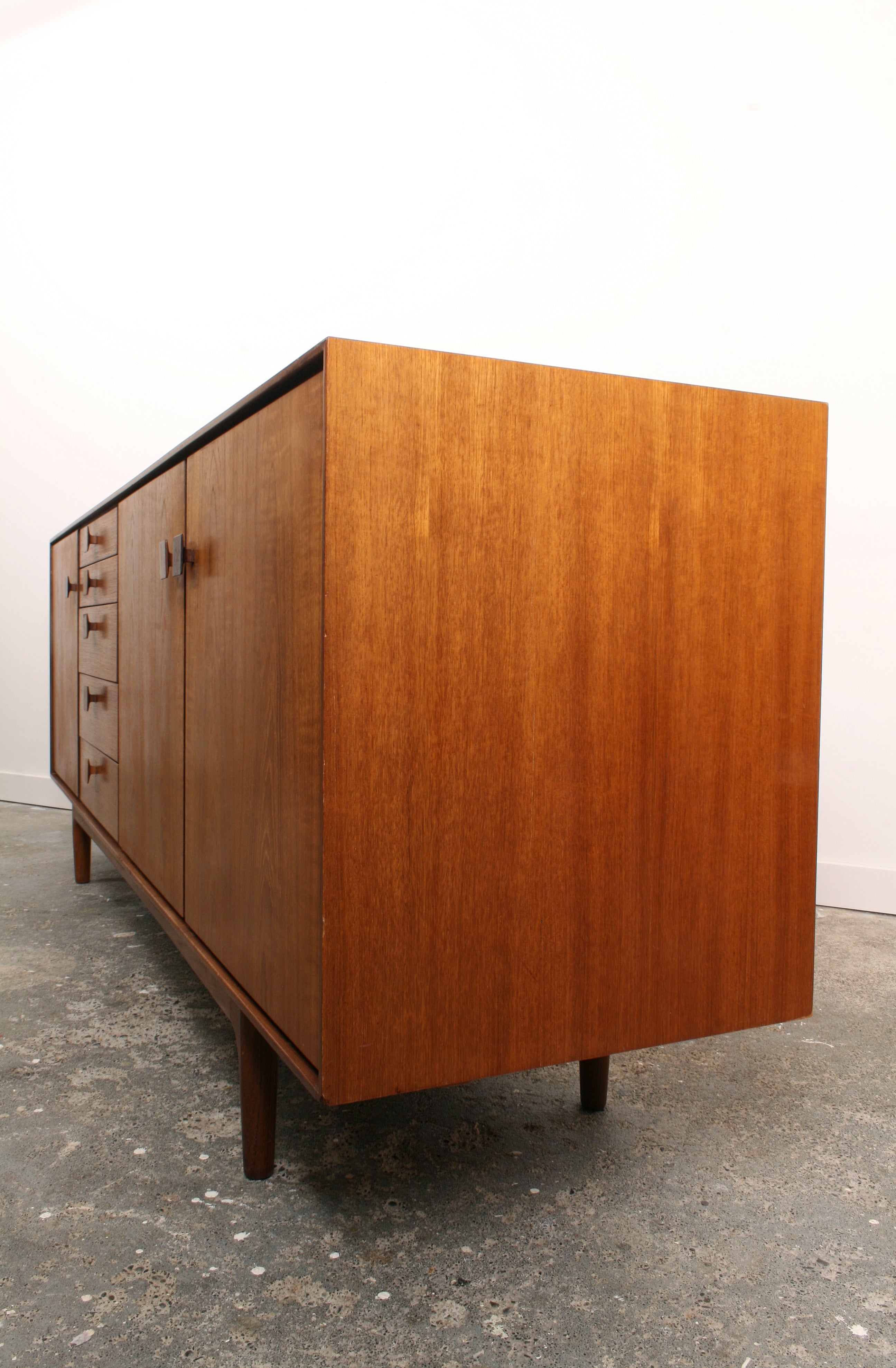 Mid Century teak sideboard in oblique view from right end.