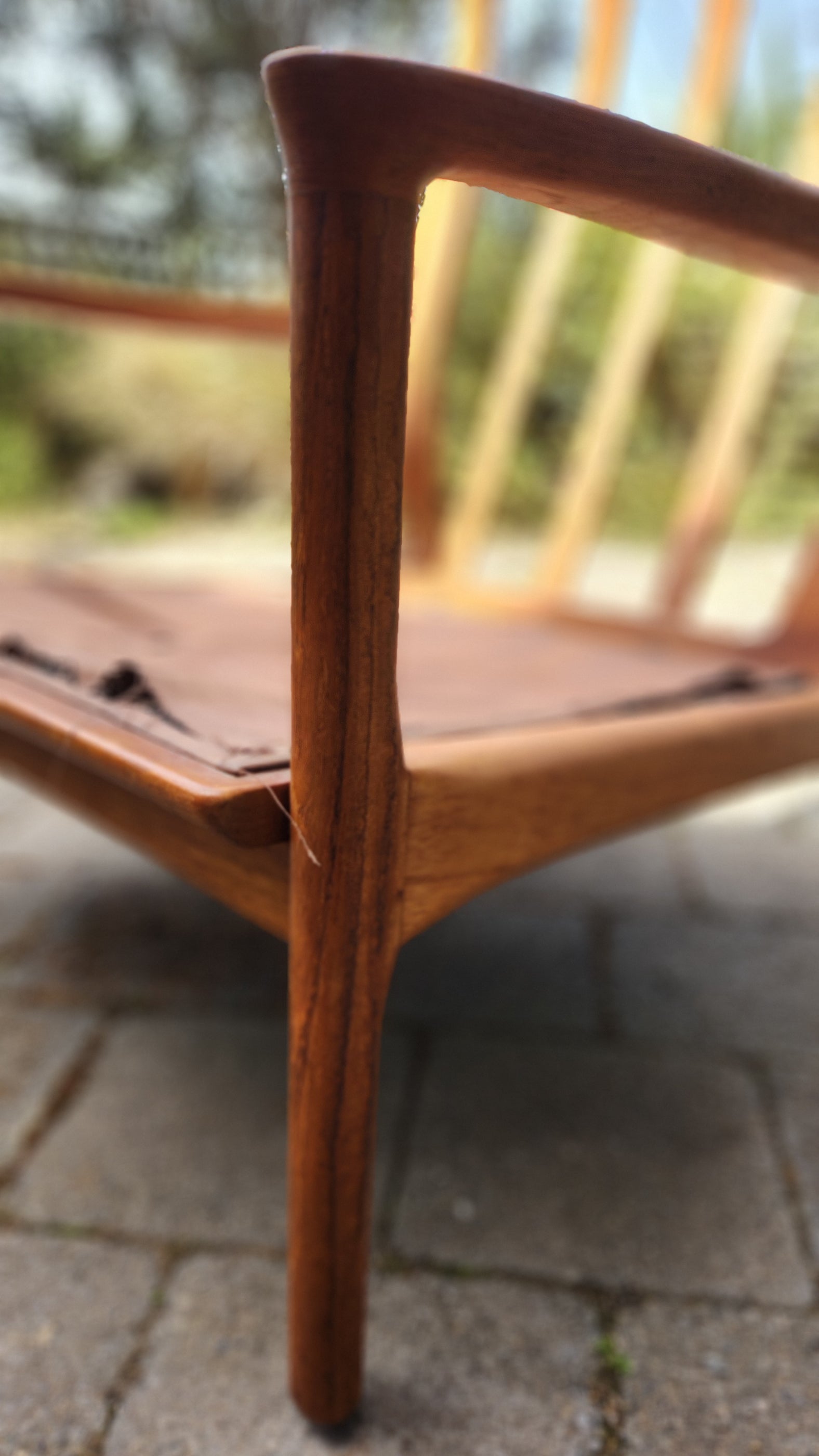 German Mid Century armchair by Mann Mobel in Teak. Close up of front leg and arm rest.