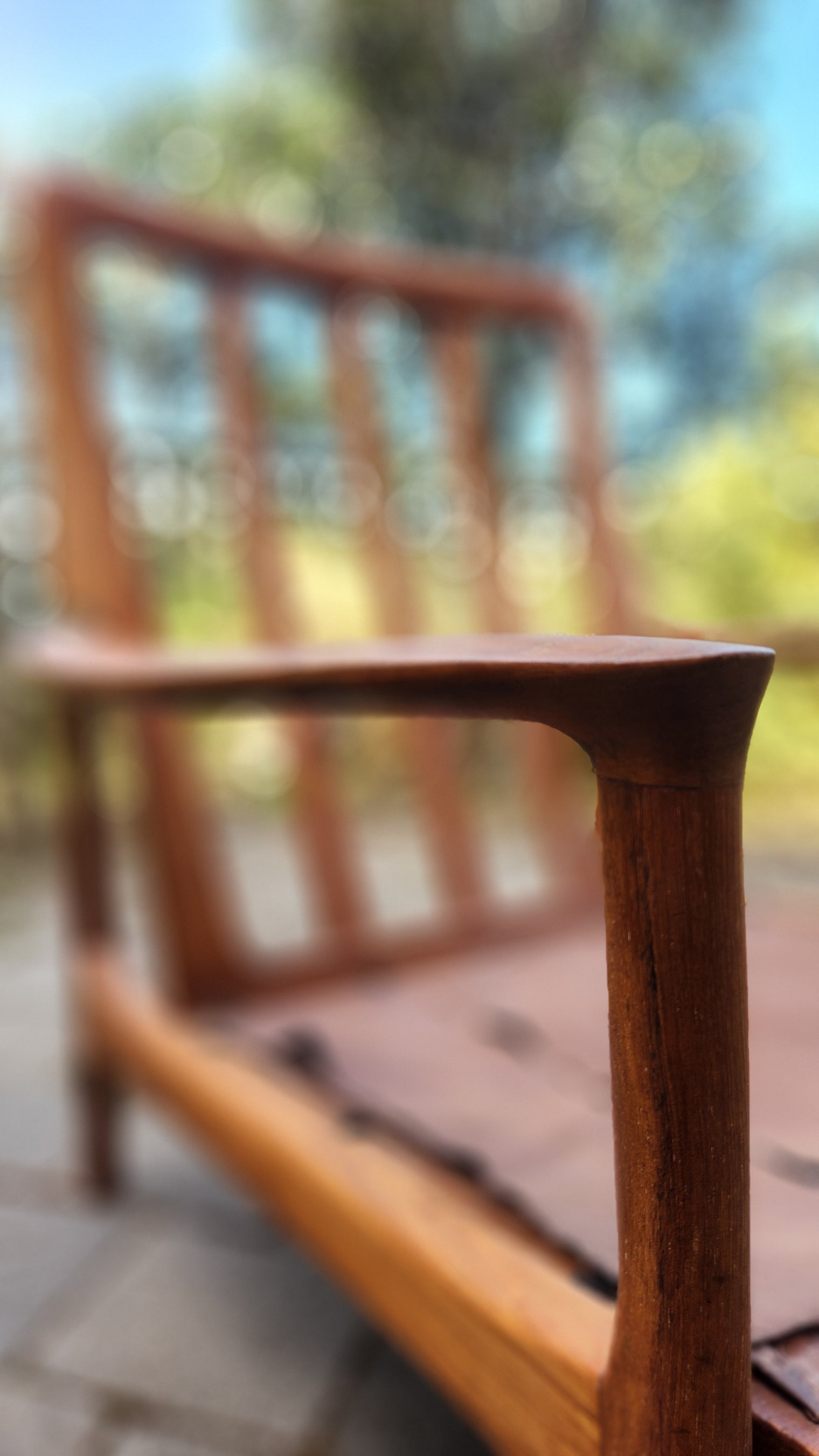 German Mid Century armchair by Mann Mobel in Teak. Close up of front leg and arm rest.