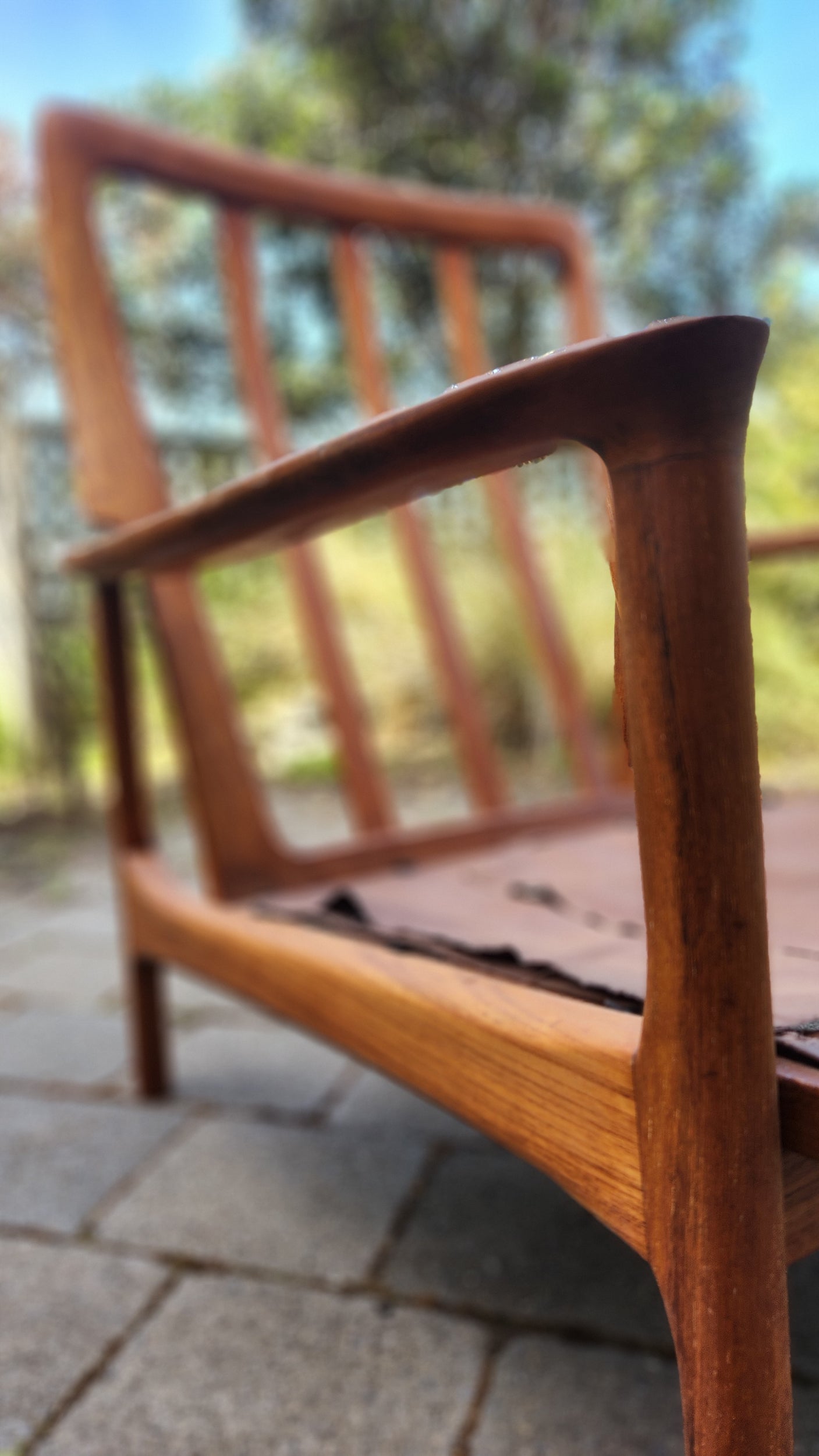 German Mid Century armchair by Mann Mobel in Teak. Close up of front leg and arm rest.