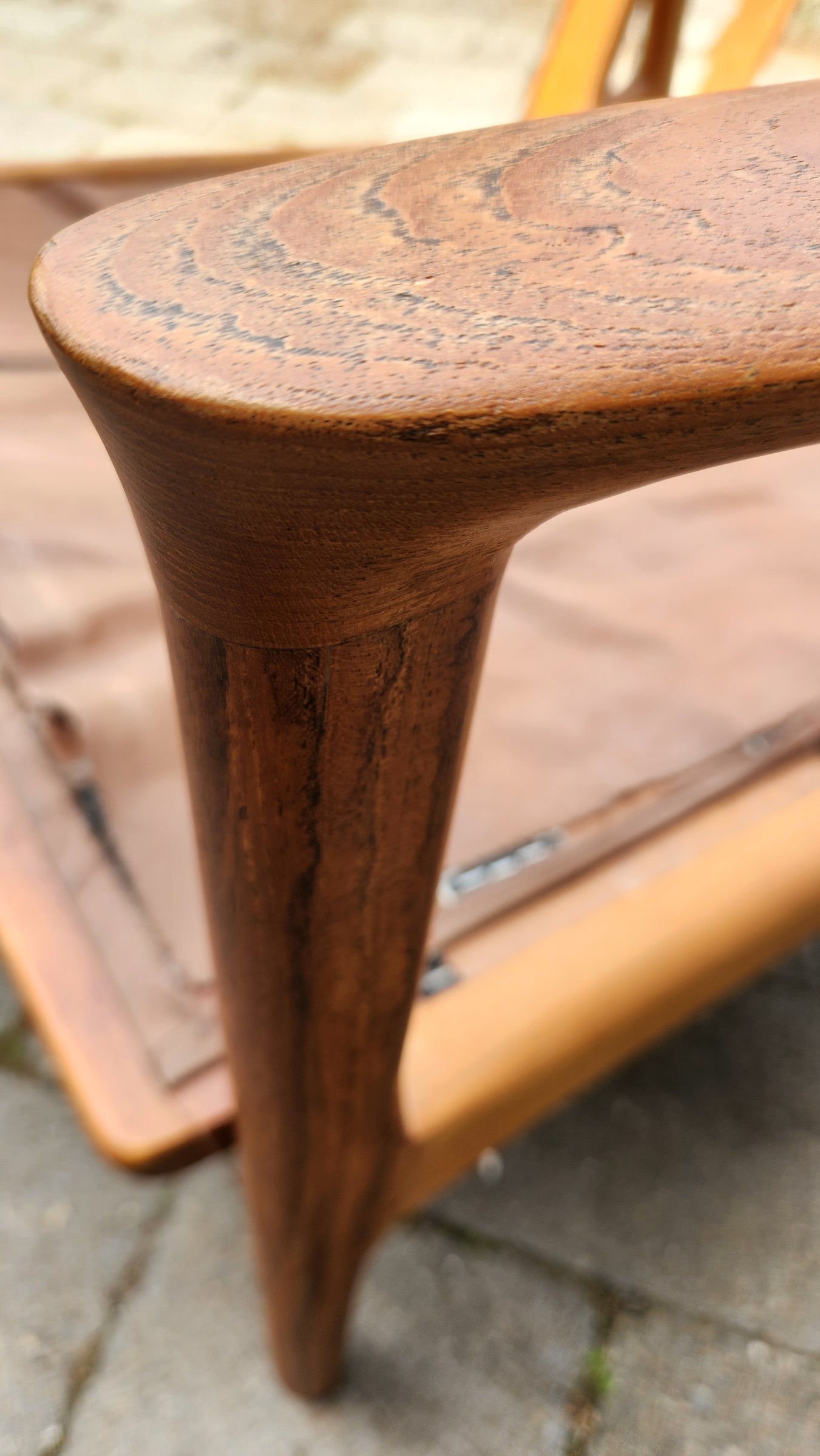 German Mid Century armchair by Mann Mobel in Teak. Close up of front leg and arm rest.