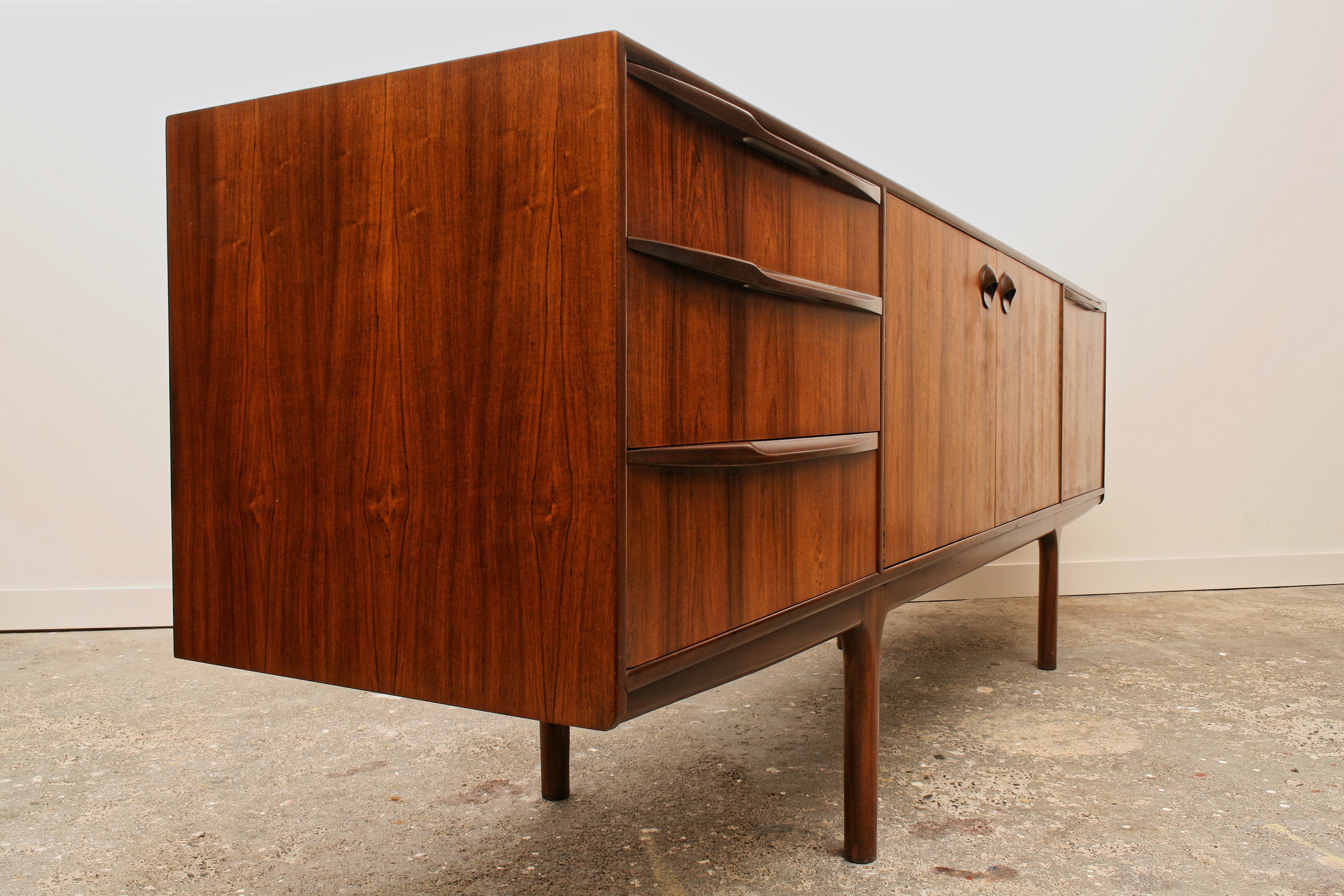 Rosewood sideboard showing left end and drawer handle detail.