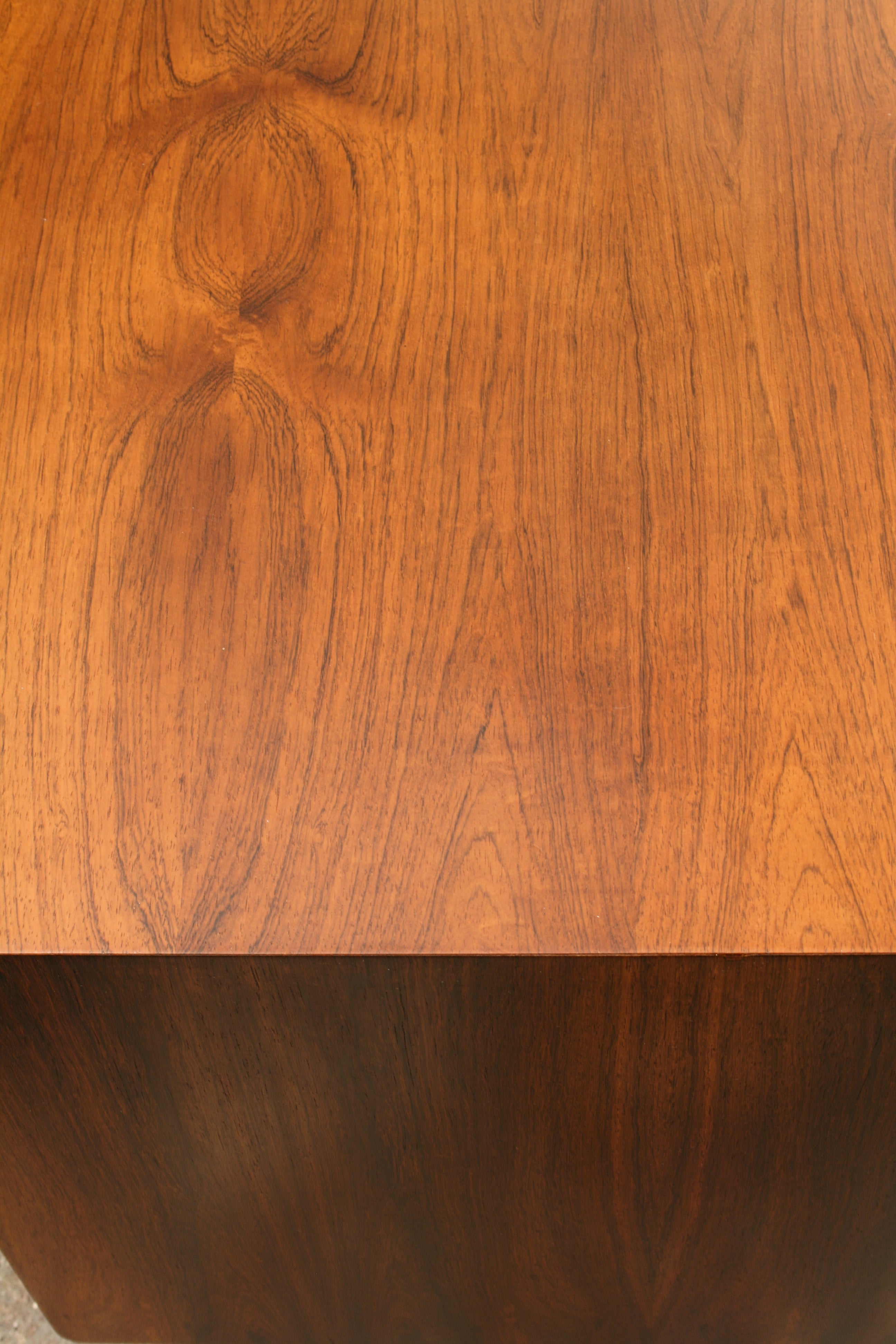 Rosewood sideboard close up join of end panel and top.
