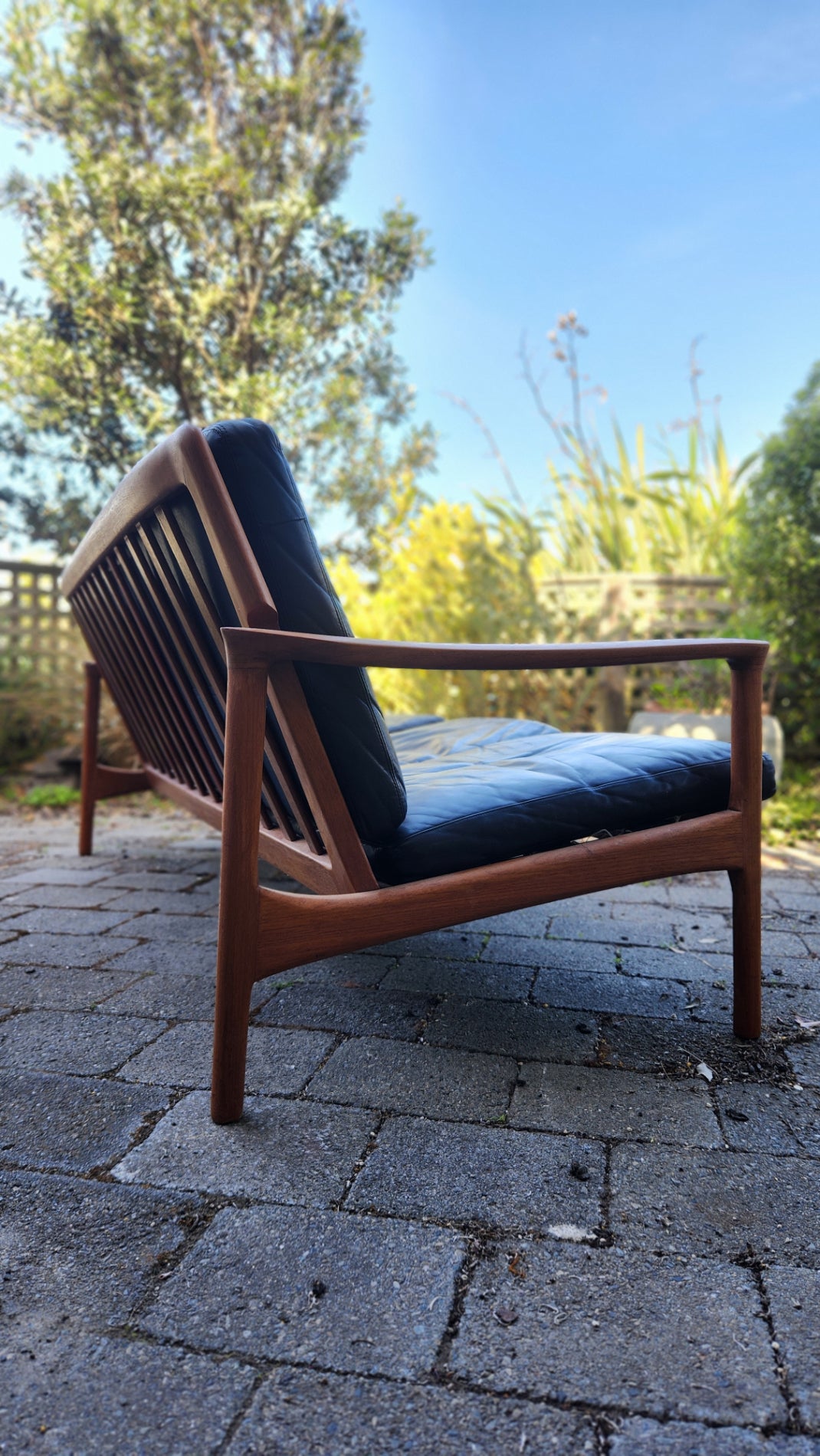 Teak Mid Century sofa by Mann Mobler of West Germany. Seen from rear in profile.