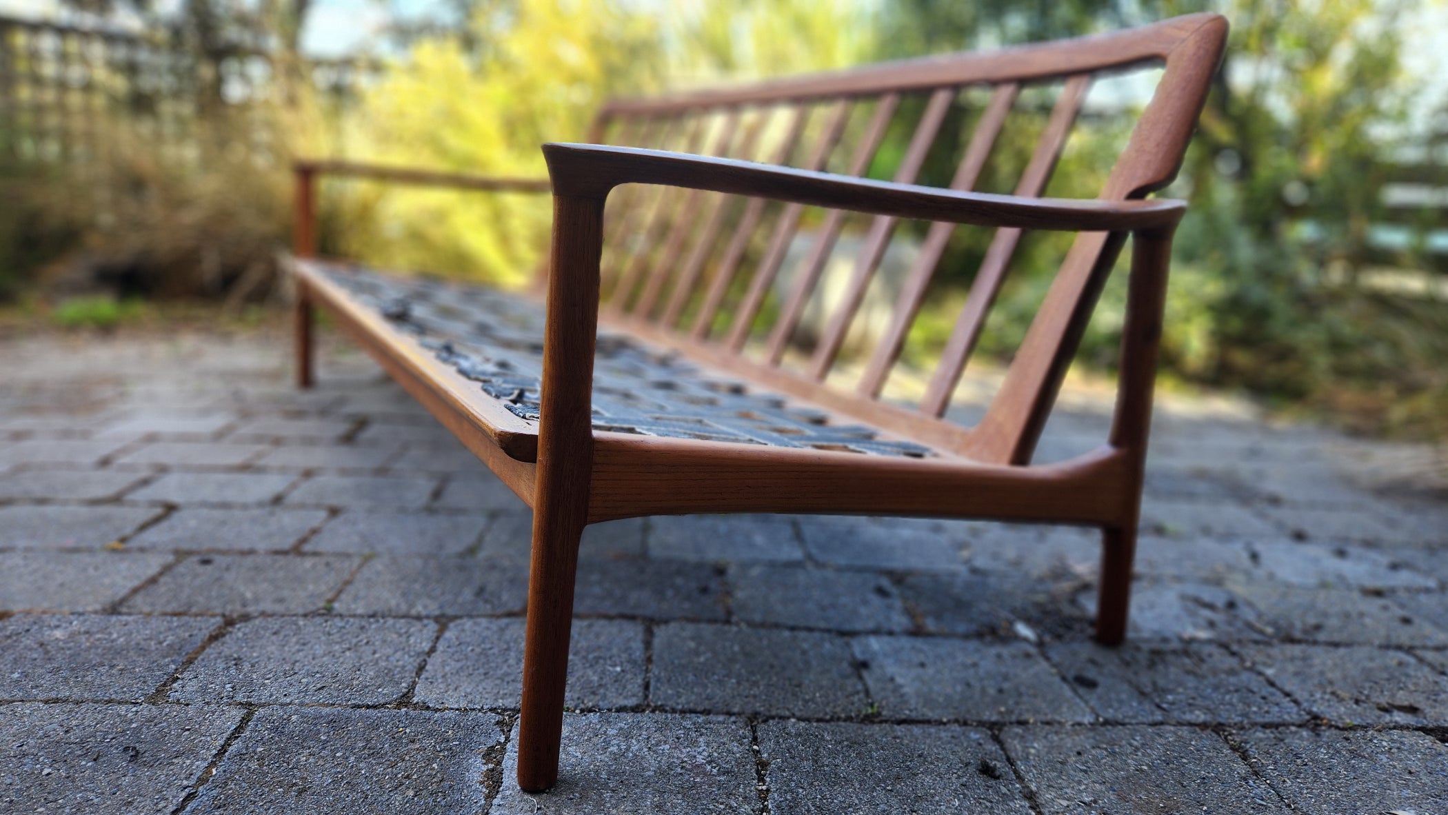 Teak Mid Century sofa by Mann Mobler of West Germany. Seen in stunning profile.