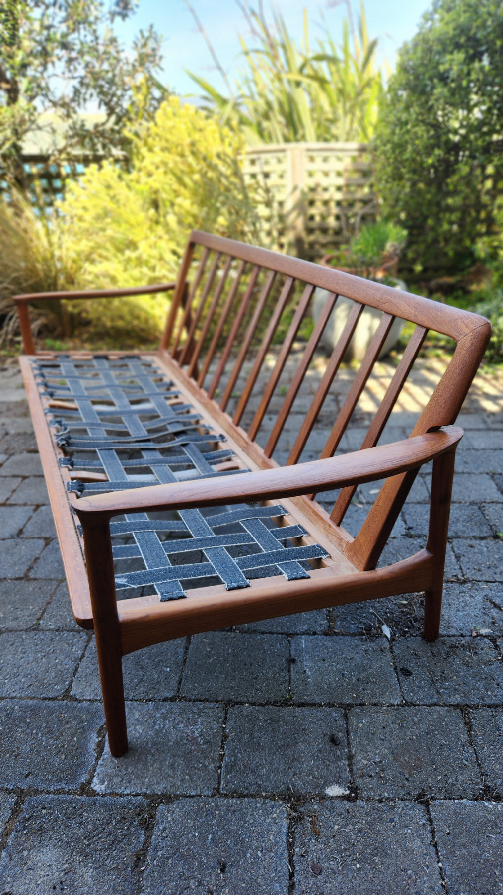 Teak Mid Century sofa by Mann Mobler of West Germany. Seen from rear in profile without cushions.
