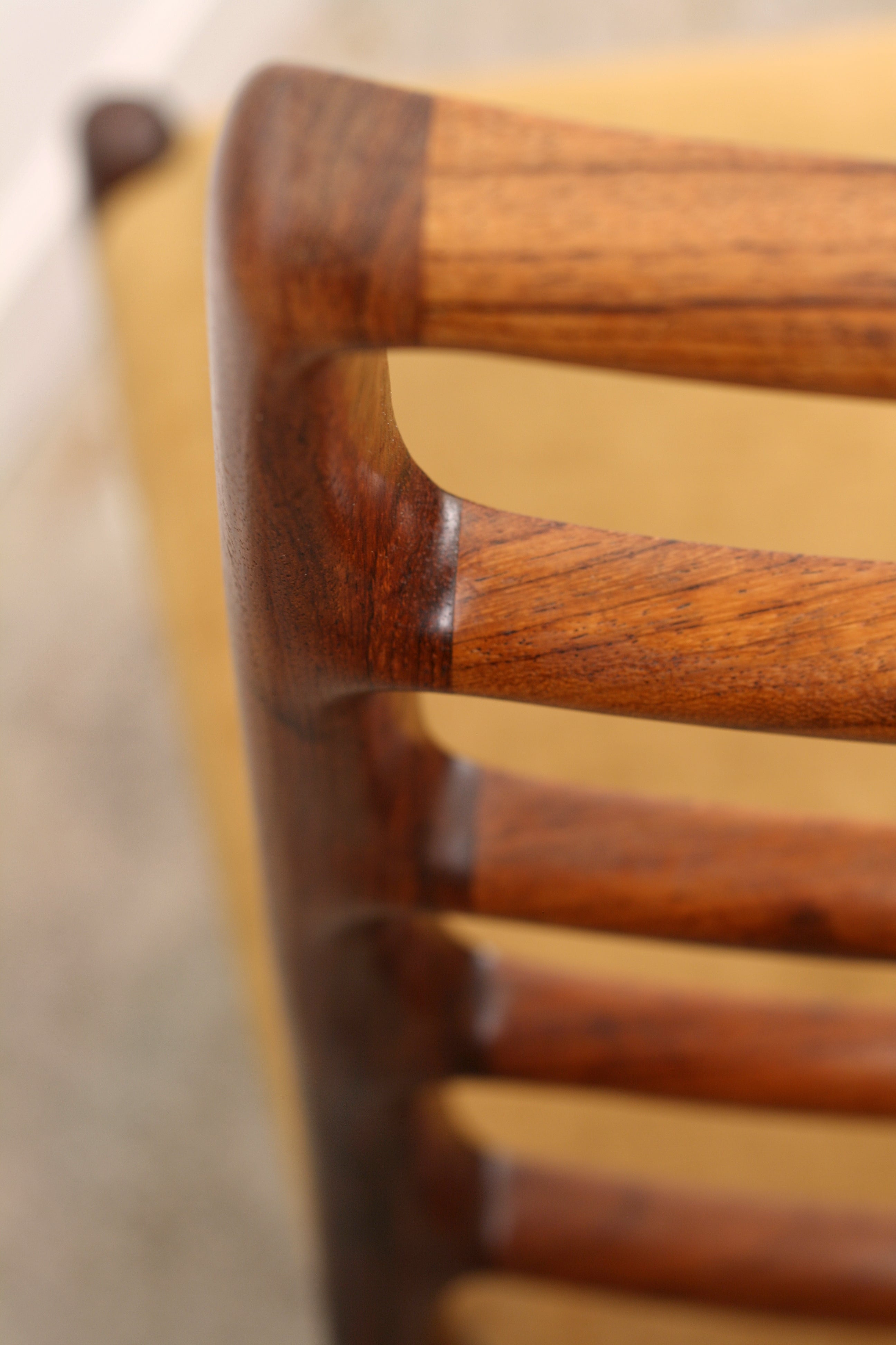 Moller Danish chair close up top ladderback detail showing curves from rear.