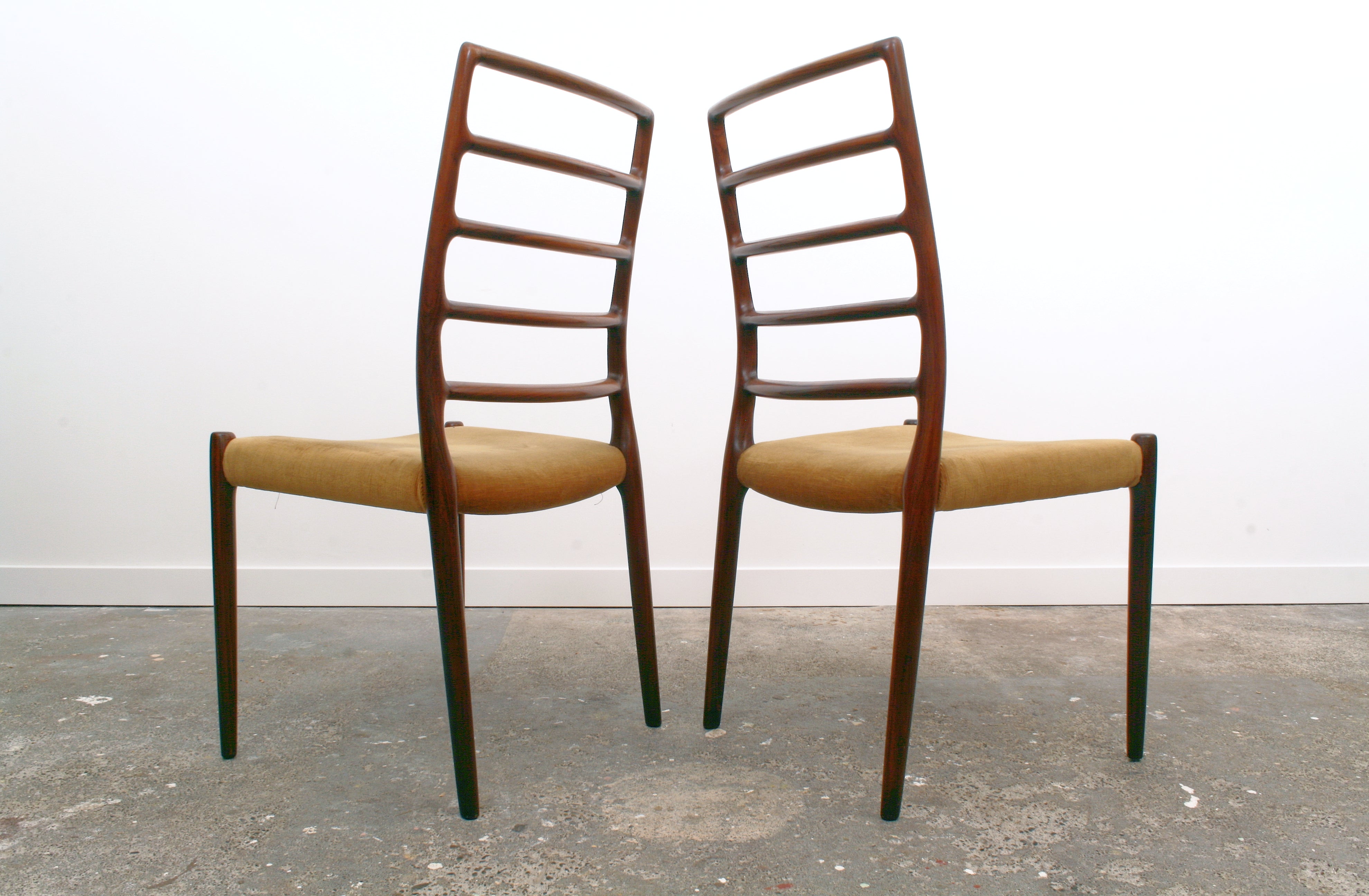 Moller Danish chairs pair showing their elegant back detail.