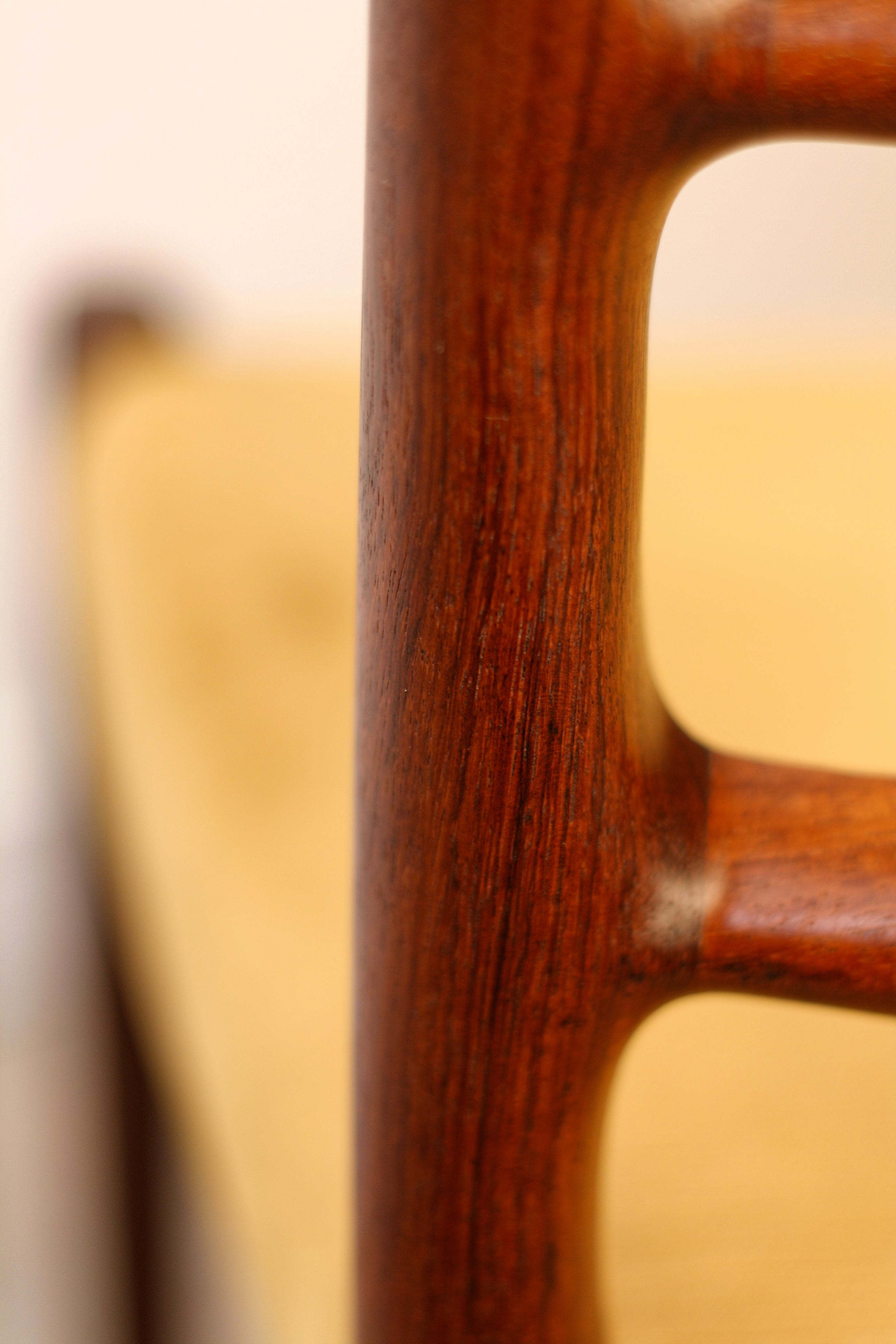 Moller Danish chairs extra close up of  ladderback curves and joints and decorative colour and grain.