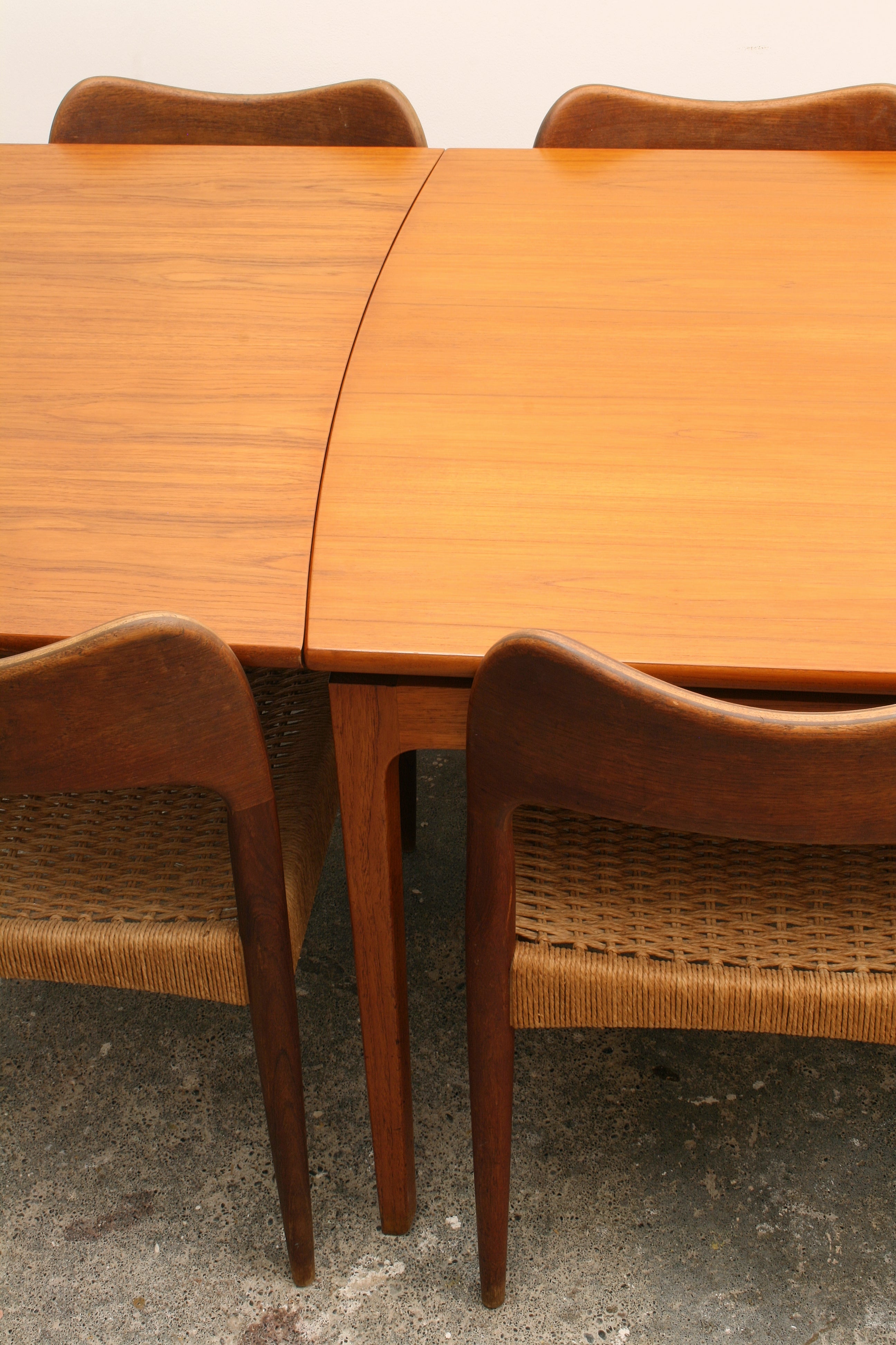 Mid Century Teak Dining Tablel viewing the curved detail to the tables end.