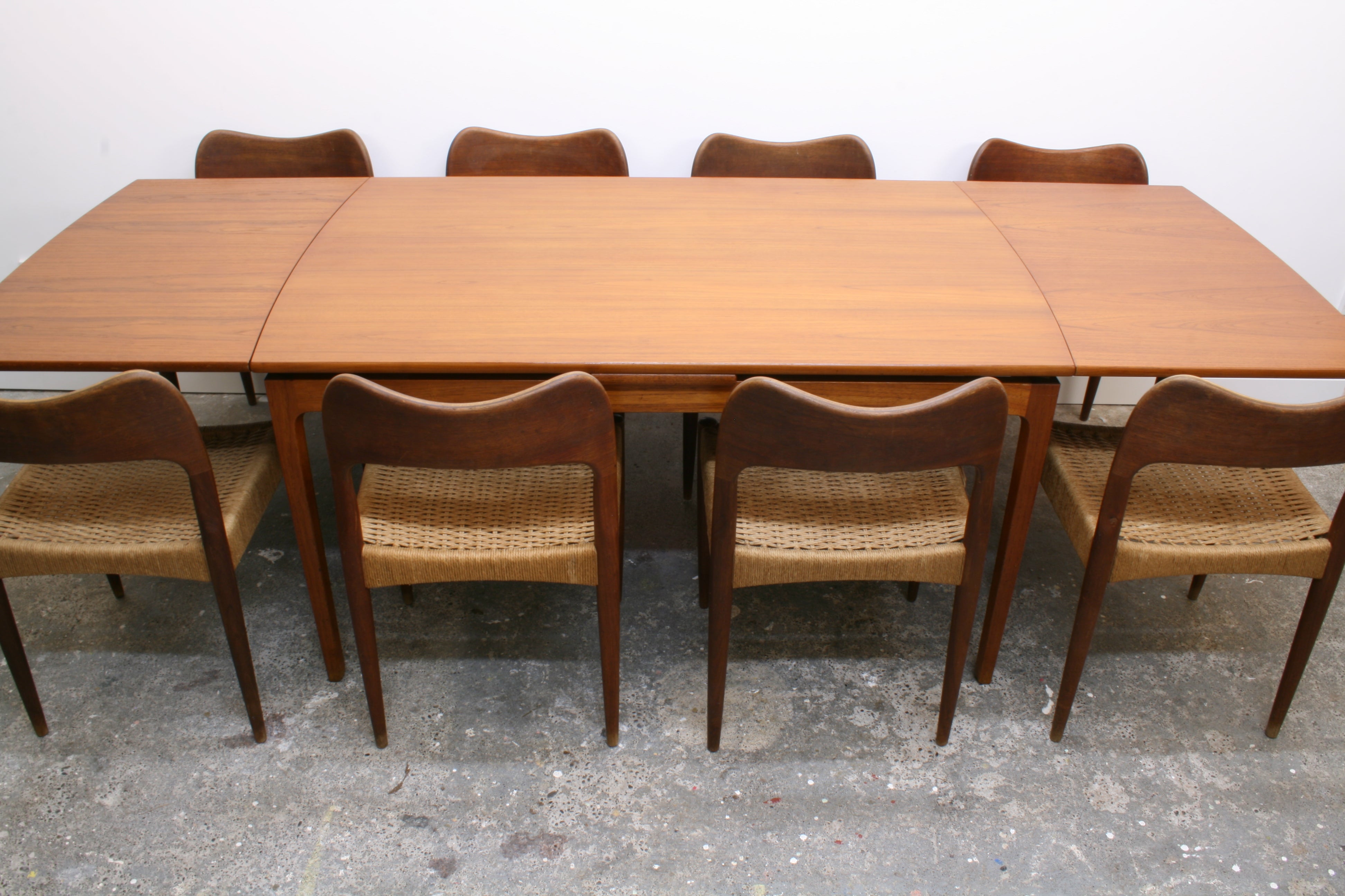 Mid Century Teak Dining Table fully extended with chairs.